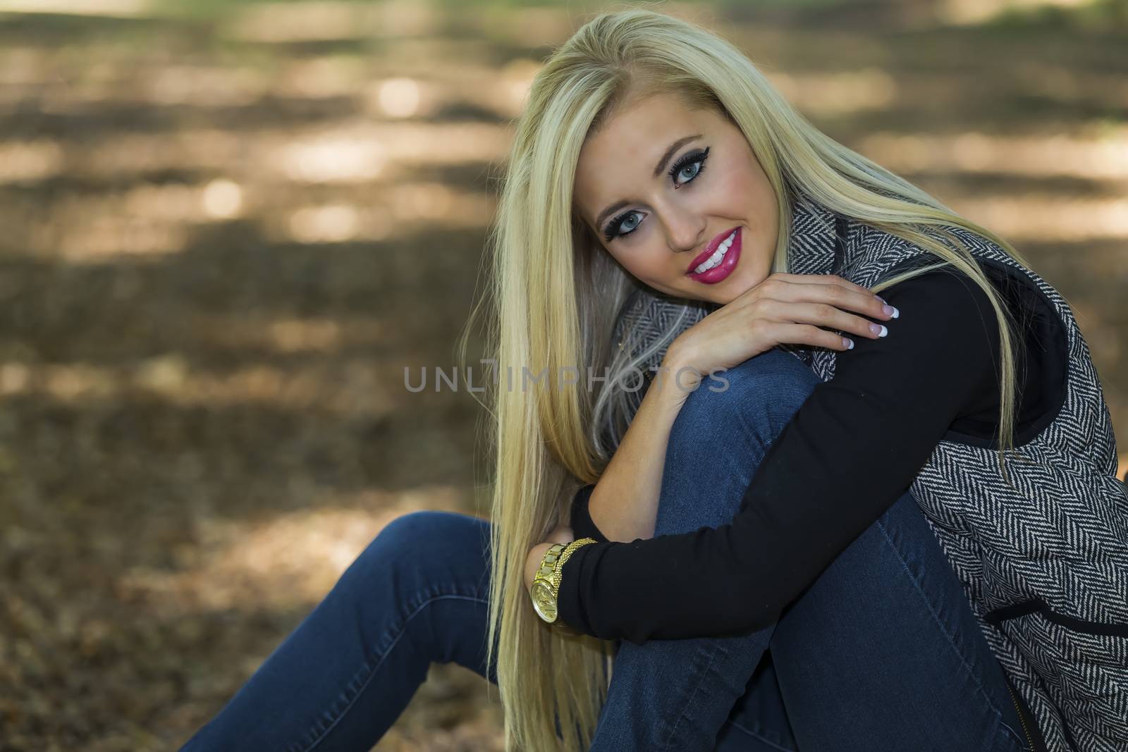 A blonde model posing in an outdoor environment