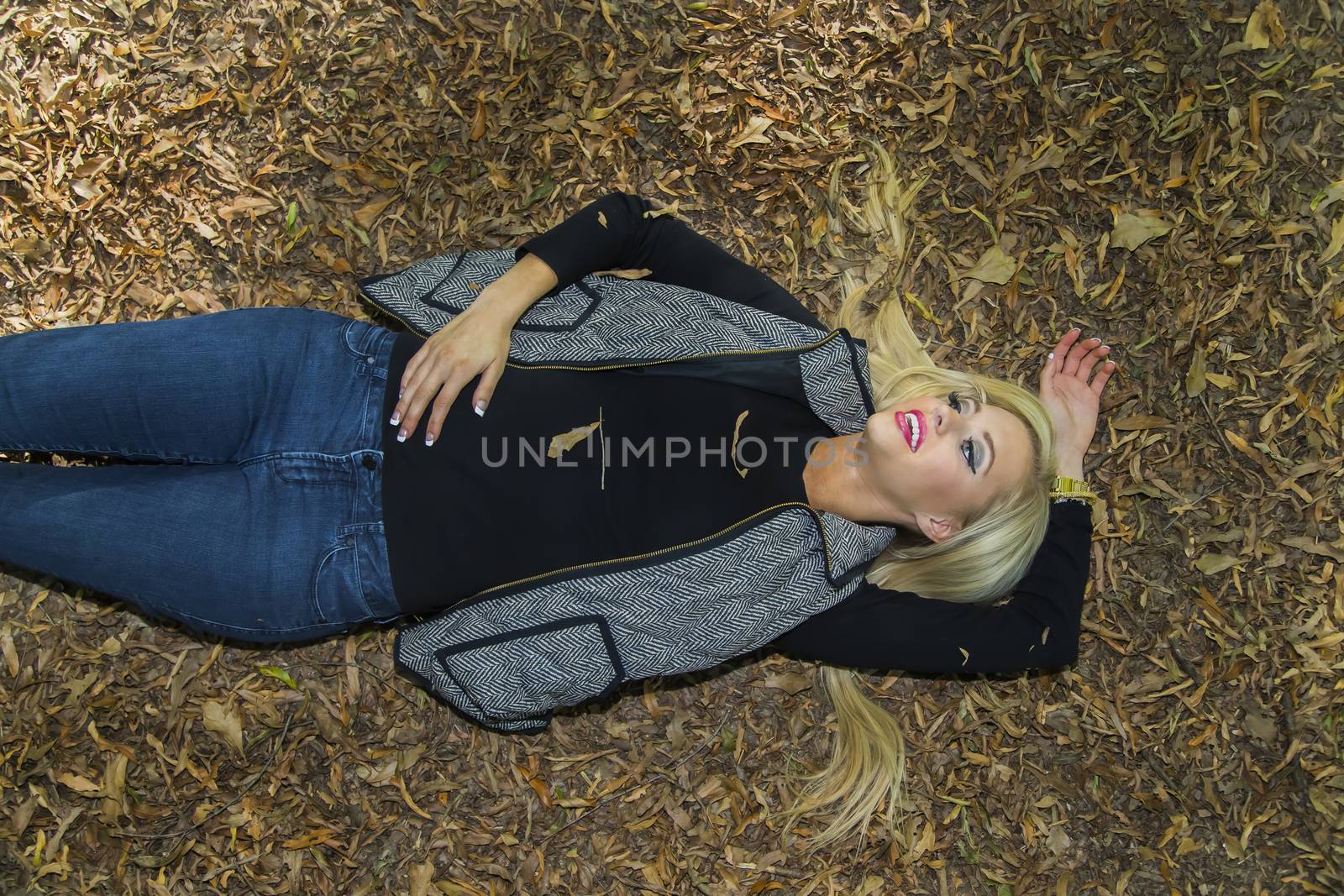 A blonde model posing in an outdoor environment