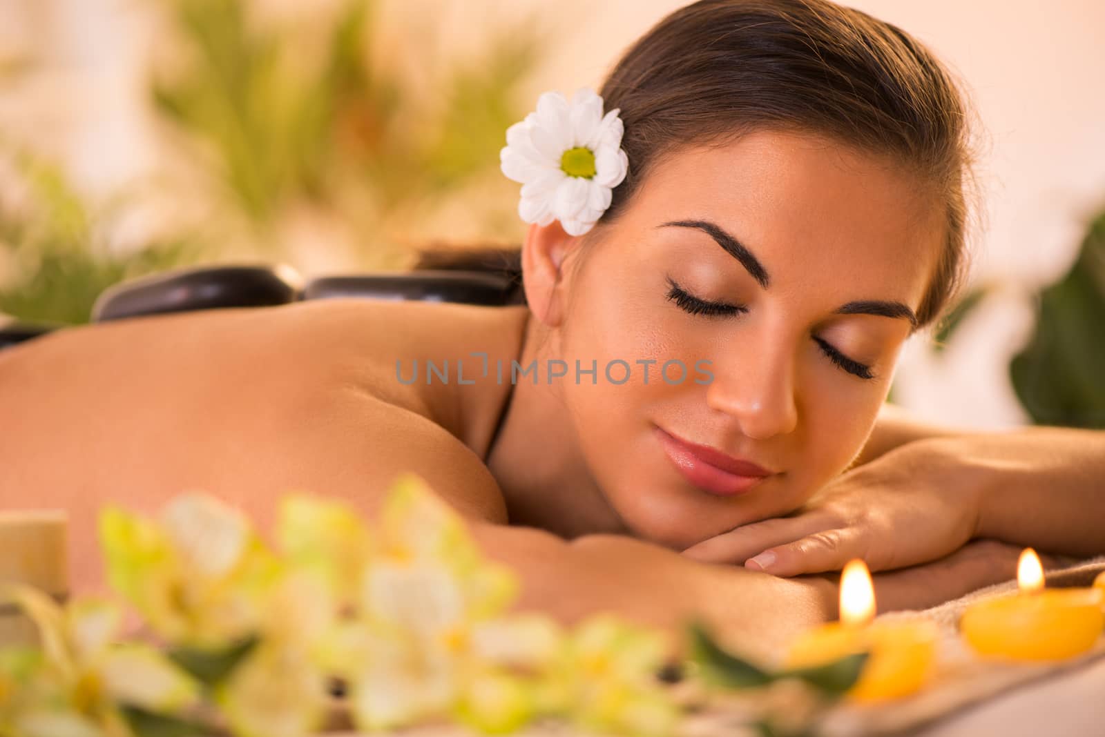 Young beautiful woman relaxing and enjoying in spa salon.