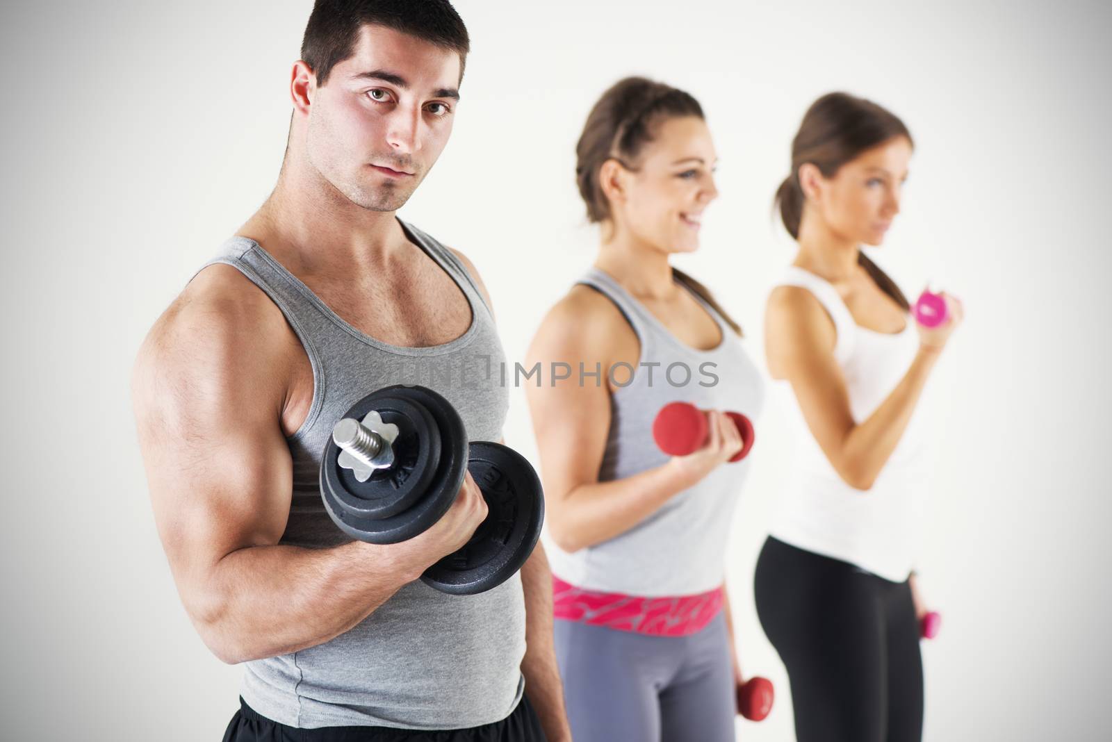 Group of people exercising and lifting the weights with biceps exercise.