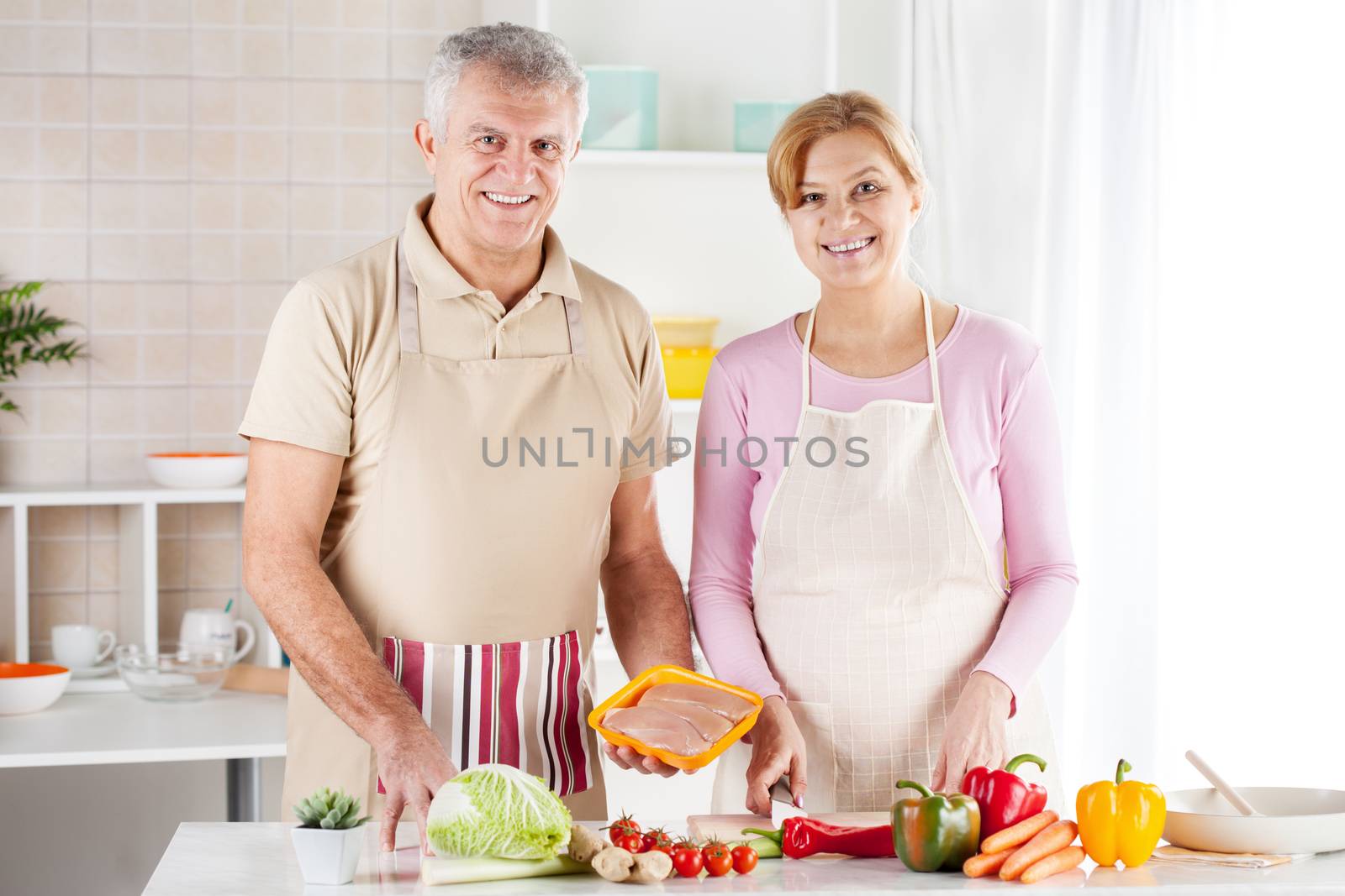 Senior Couple in the kitchen by MilanMarkovic78