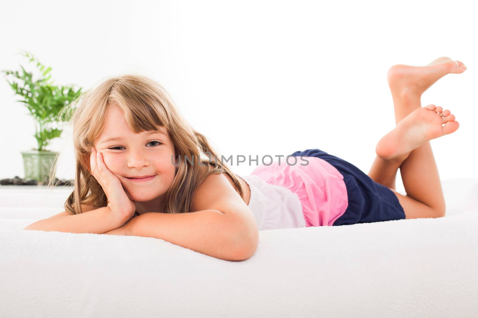 Cute little girl lying on the bed