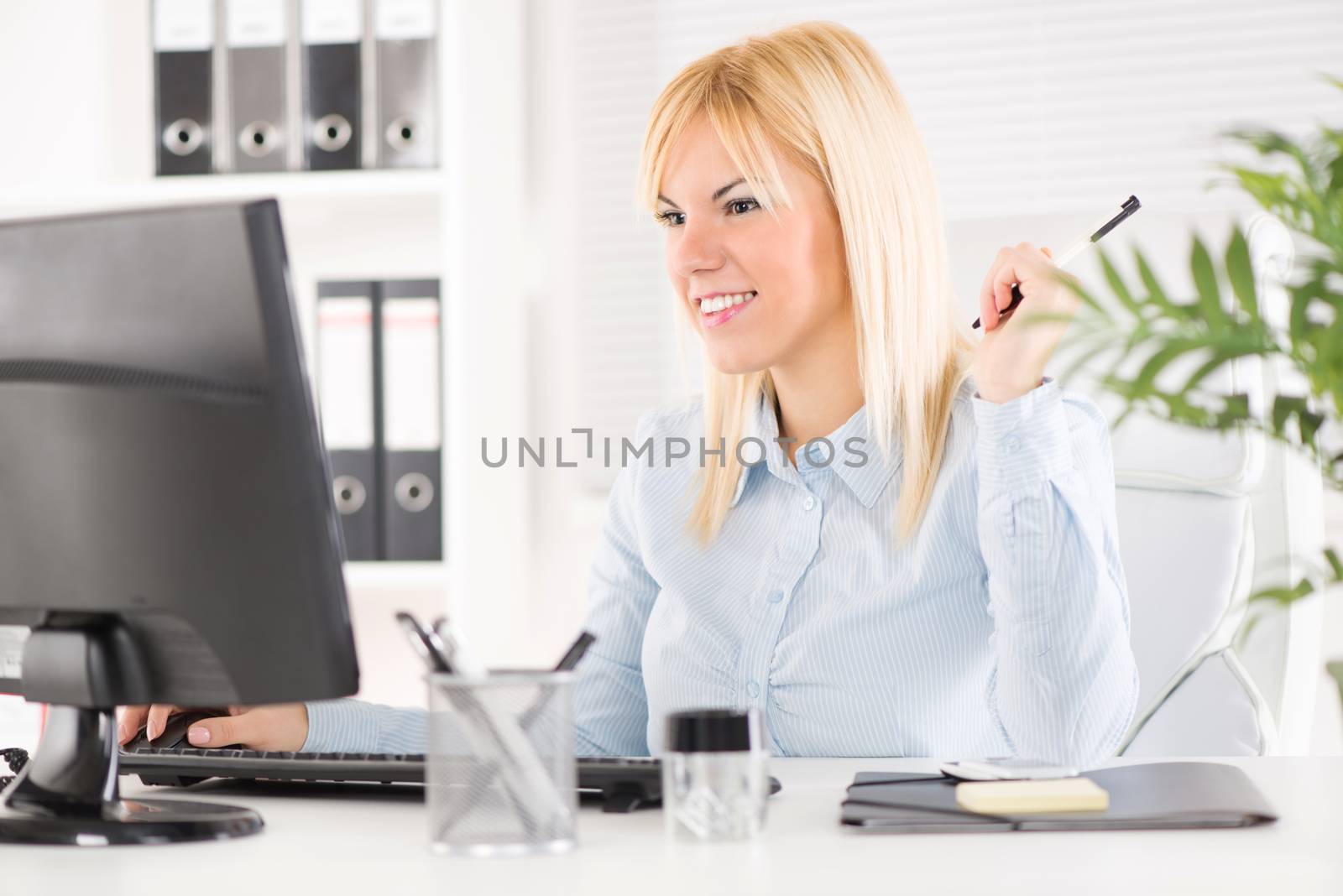 Beautiful Businesswoman working on the computer in the office.