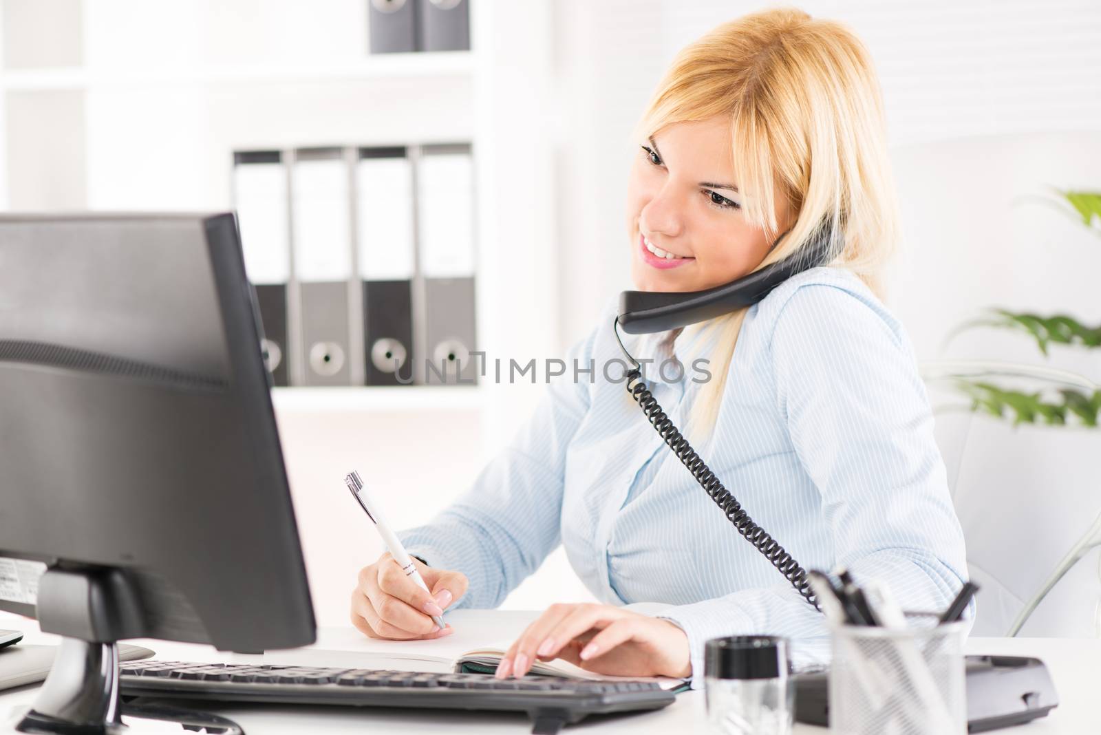 Beautiful Businesswoman telephoning and working in the office.