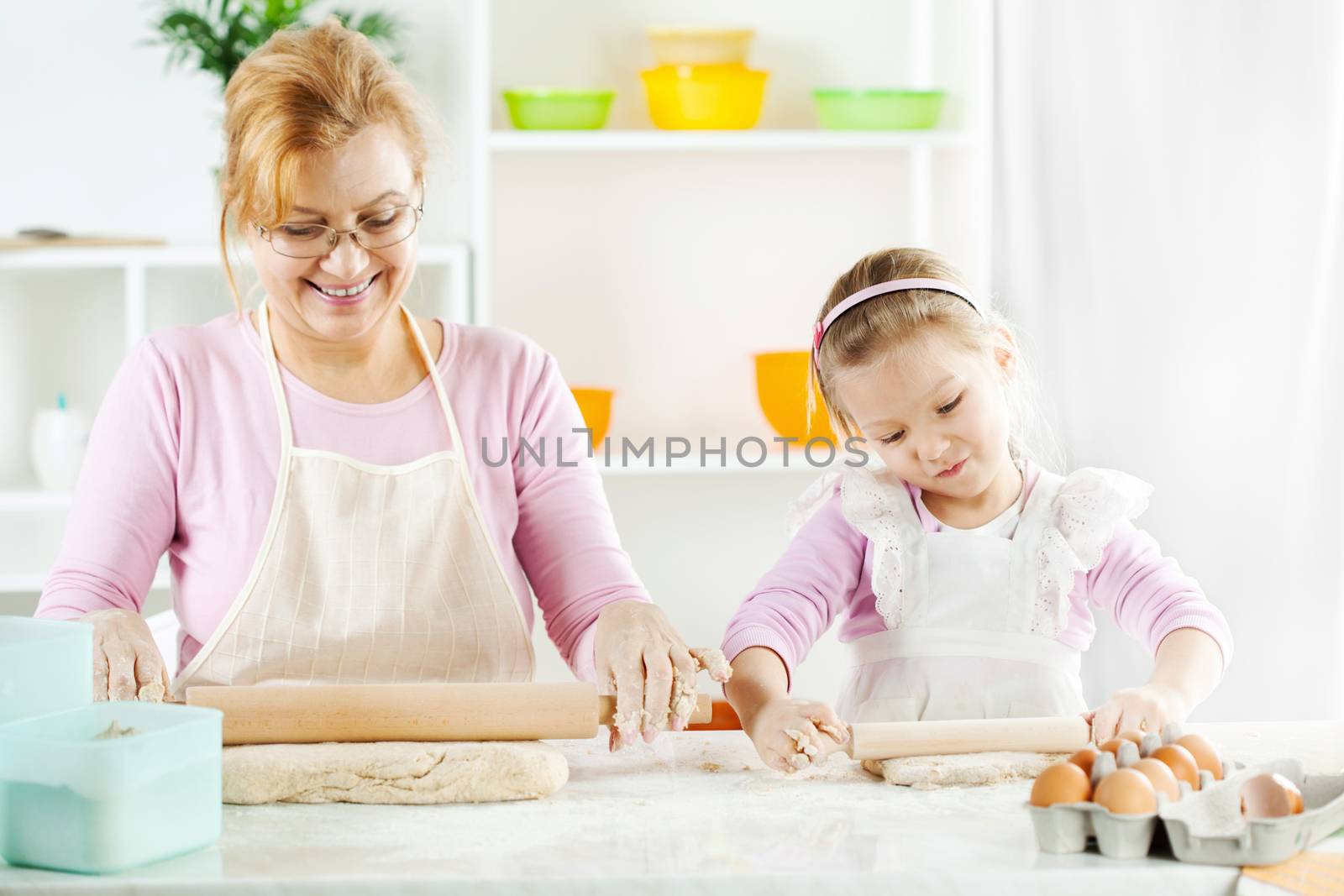 Grandmother and granddaughter making Dough by MilanMarkovic78