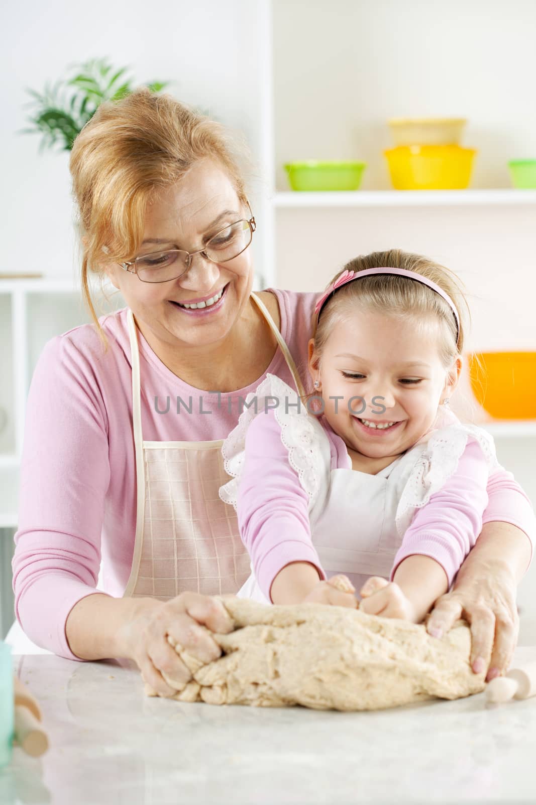 Happy Little Girl with grandmother in the kitchen by MilanMarkovic78