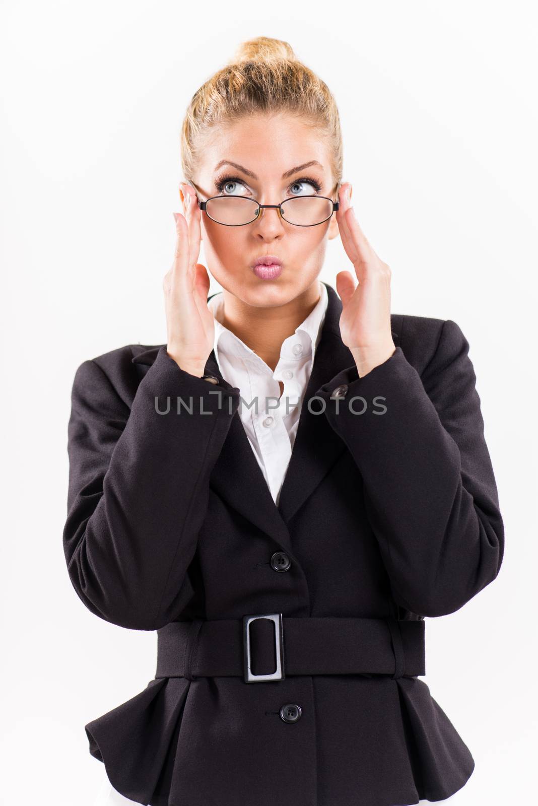 Portrait of attractive businesswoman with glasses. She is thinking and looking up.