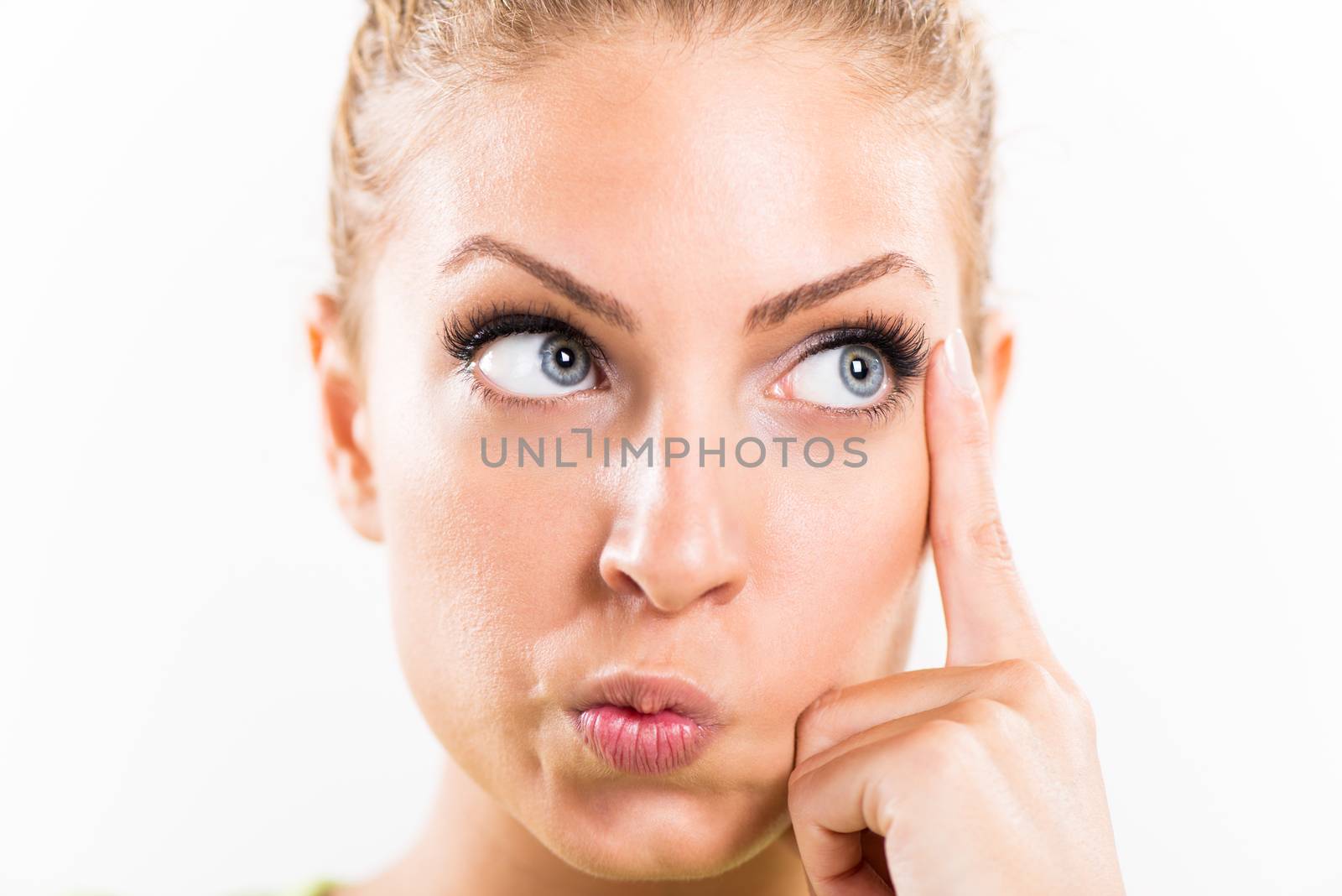 Portrait of beautiful young conceived woman thinking. Close-up with white background.