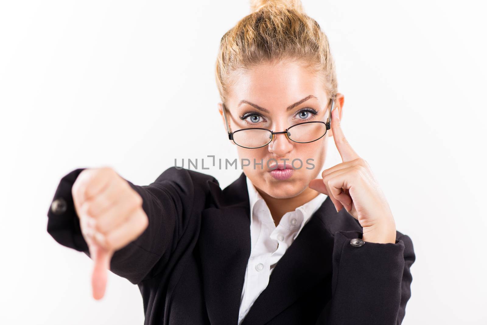 Portrait of attractive businesswoman showing thumbs down. Looking at camera.