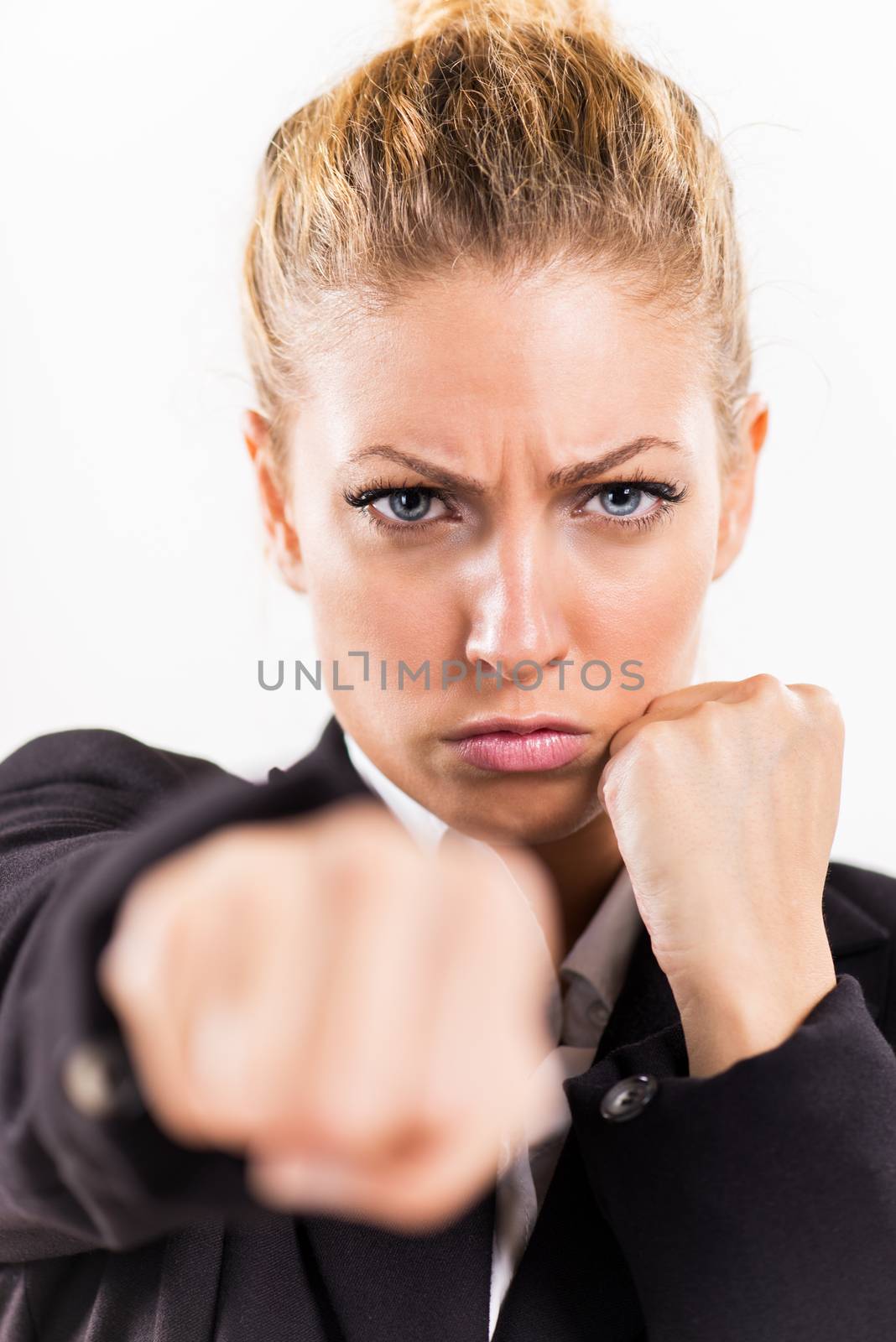 Angry Businesswoman boxing punching towards camera ready to fight.