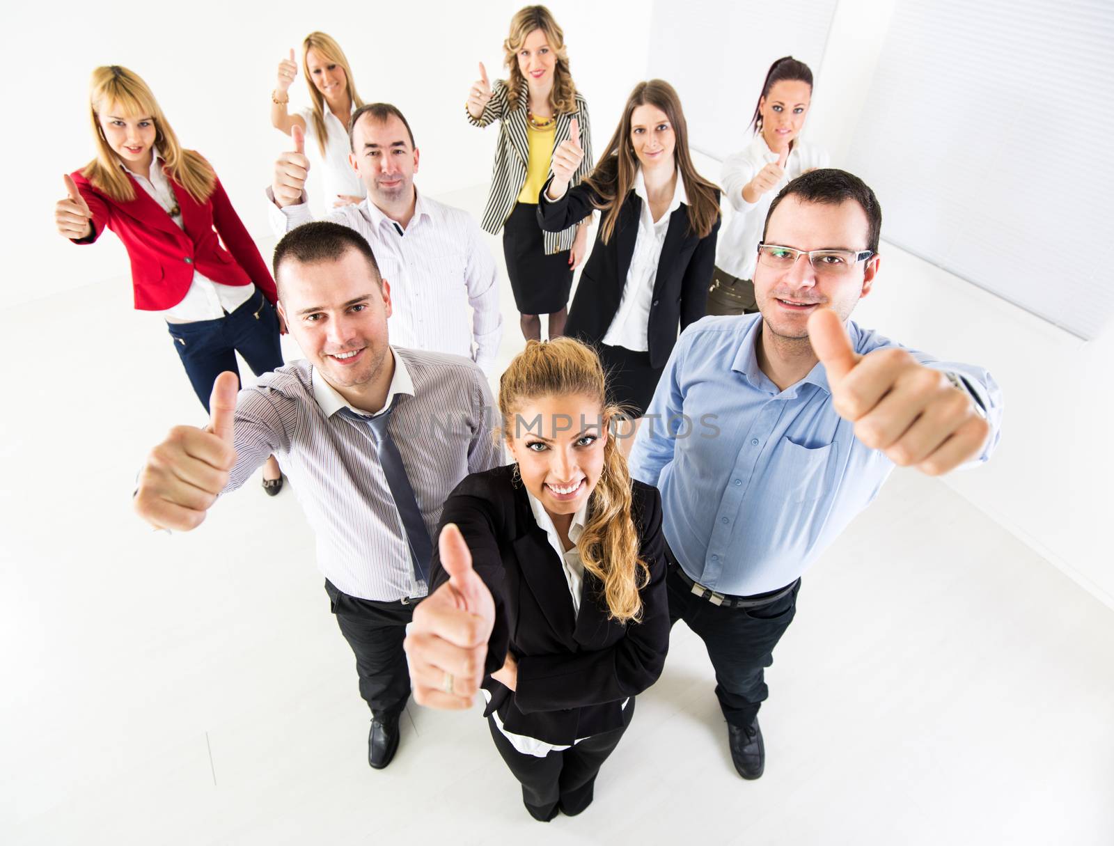 Group of a Successful Business People Showing Thumbs Up and looking at the camera.