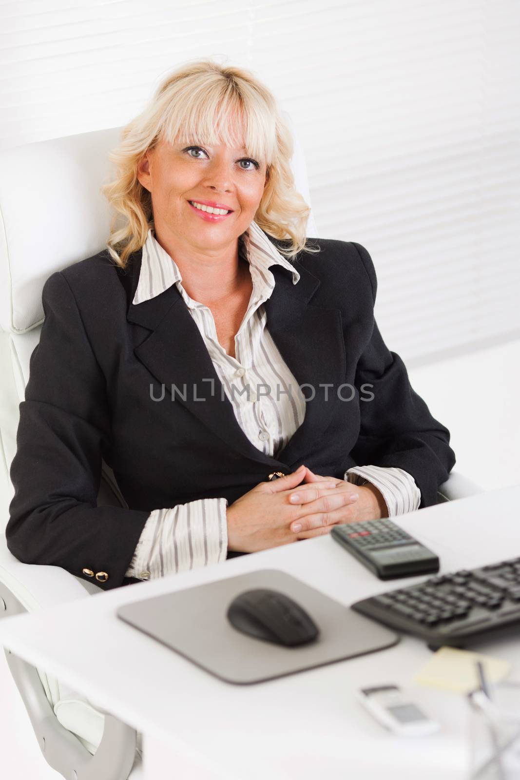 Beautiful mature Business woman sitting in the office.