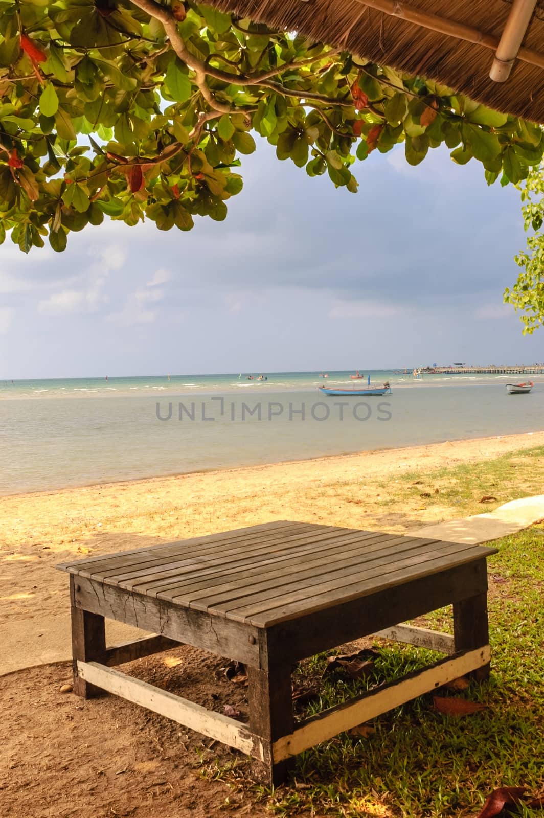 Relax on the beach wooden table. by ngungfoto