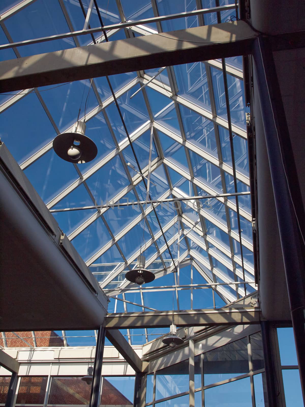 Glass roof of modern building with background of clear blue sky