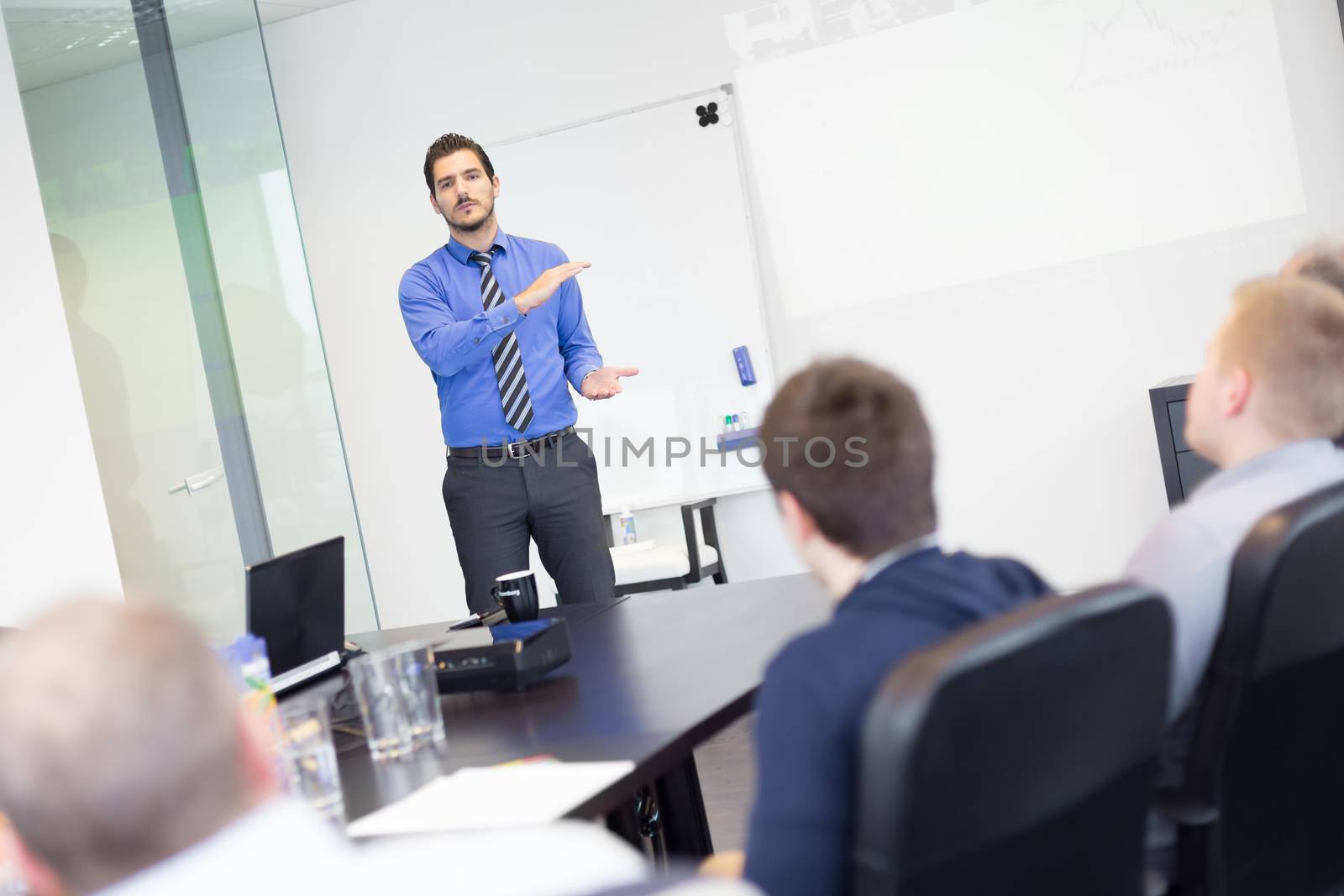 Business man making a presentation in office on job interview. Business presentation on corporate meeting. Recruiters evaluating the candidate. 