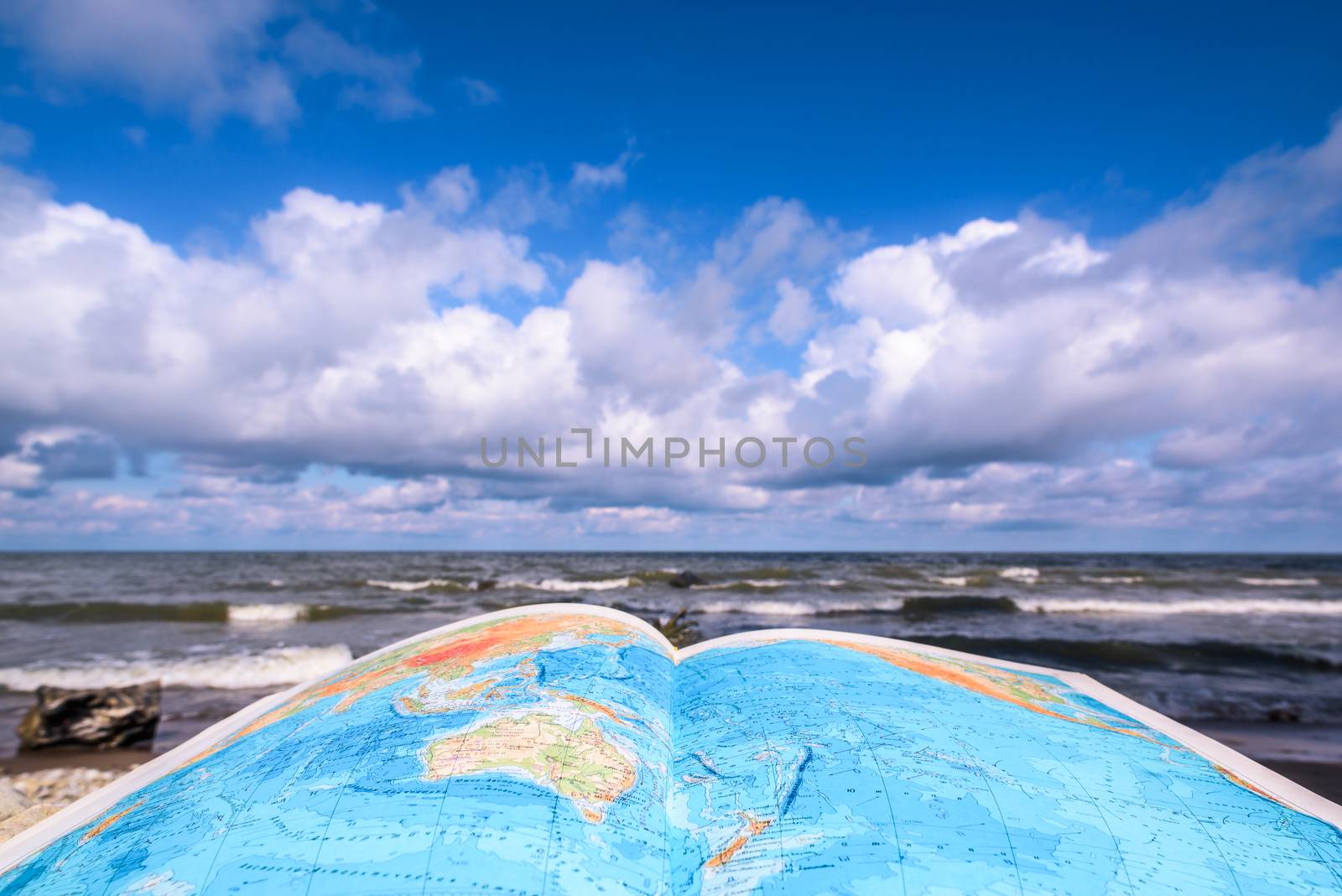 Opened atlas book on the sea coast