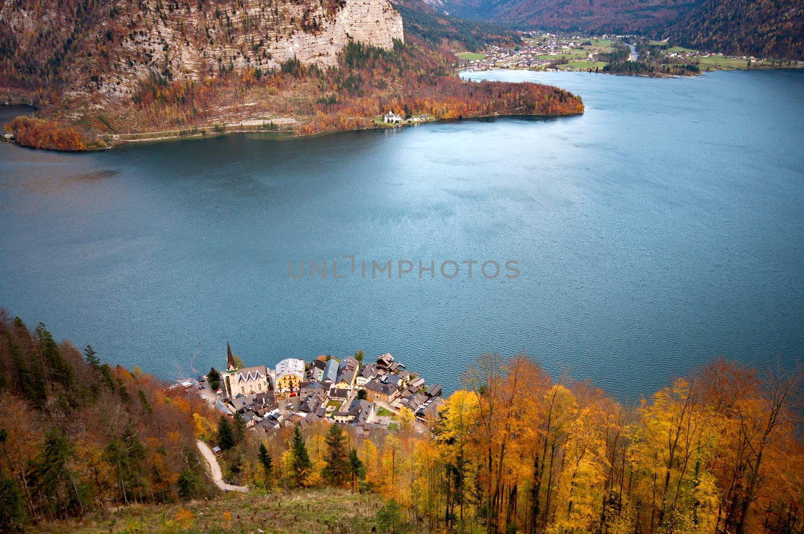 Beautiful village of Hallstatt  on the side of a lake in the Alp by anderm