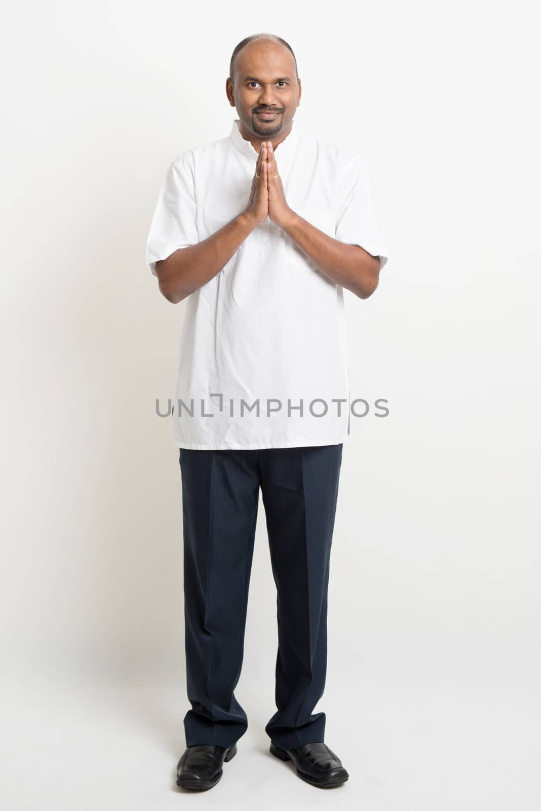 Casual mature Indian business people praying by szefei
