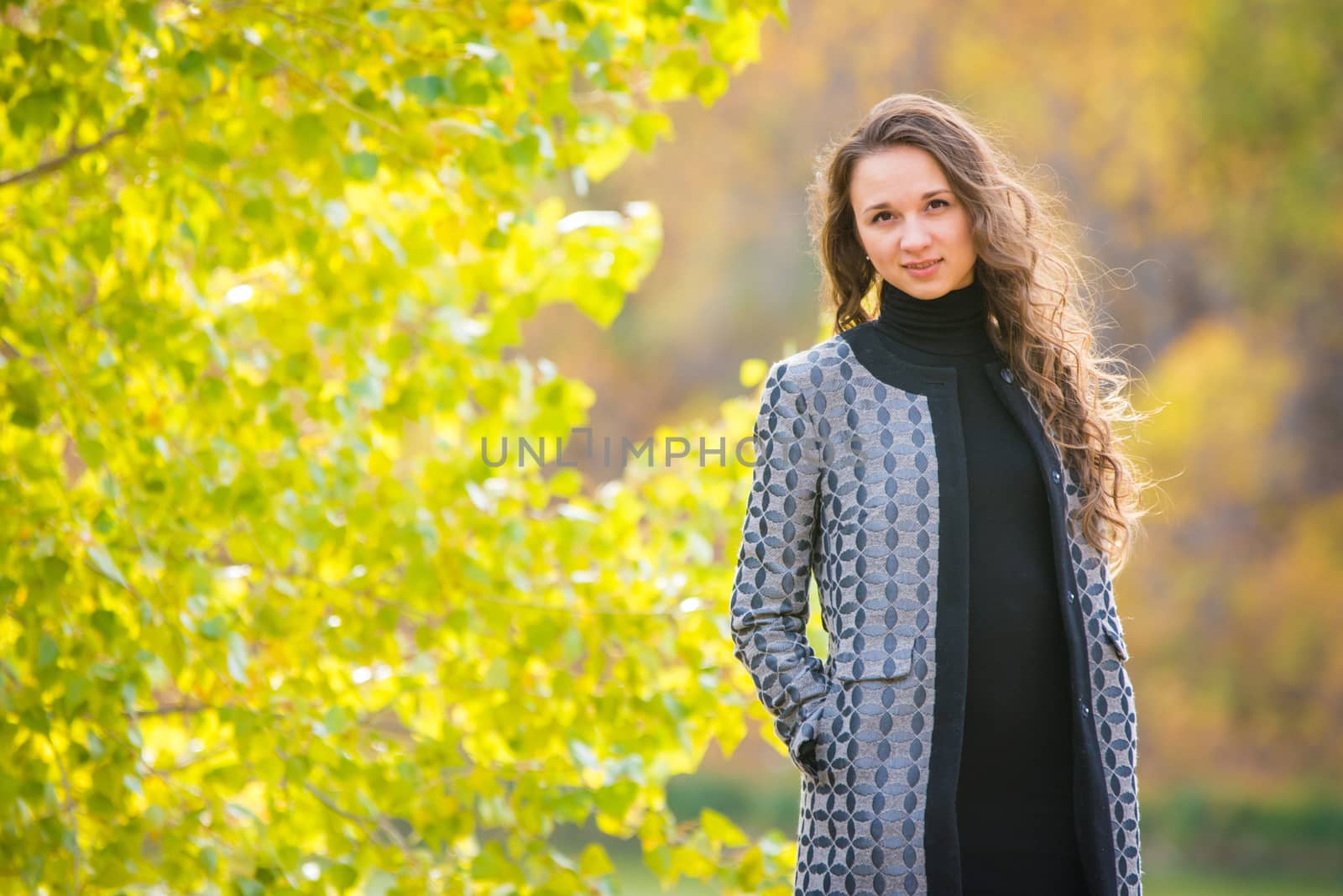 Twenty-five young beautiful girl walks by Europeans autumn forest