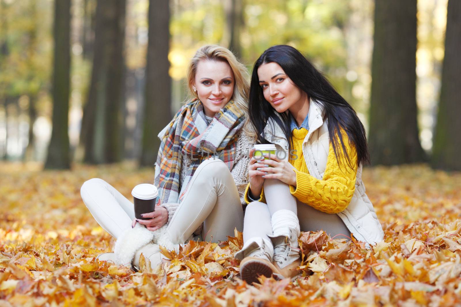 Friends with coffee in park by Yellowj