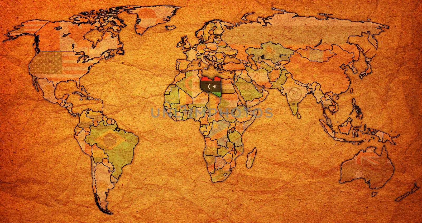 libya flag on old vintage world map with national borders