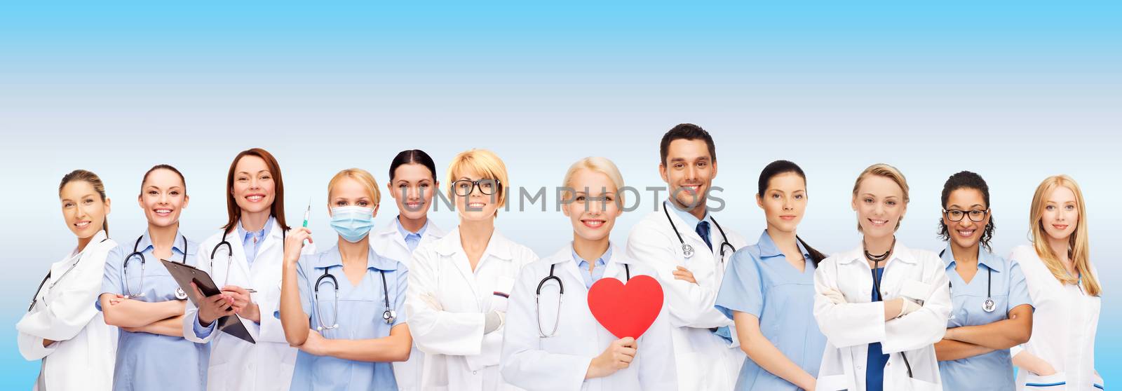 healthcare and medicine concept - smiling doctors and nurses with red heart