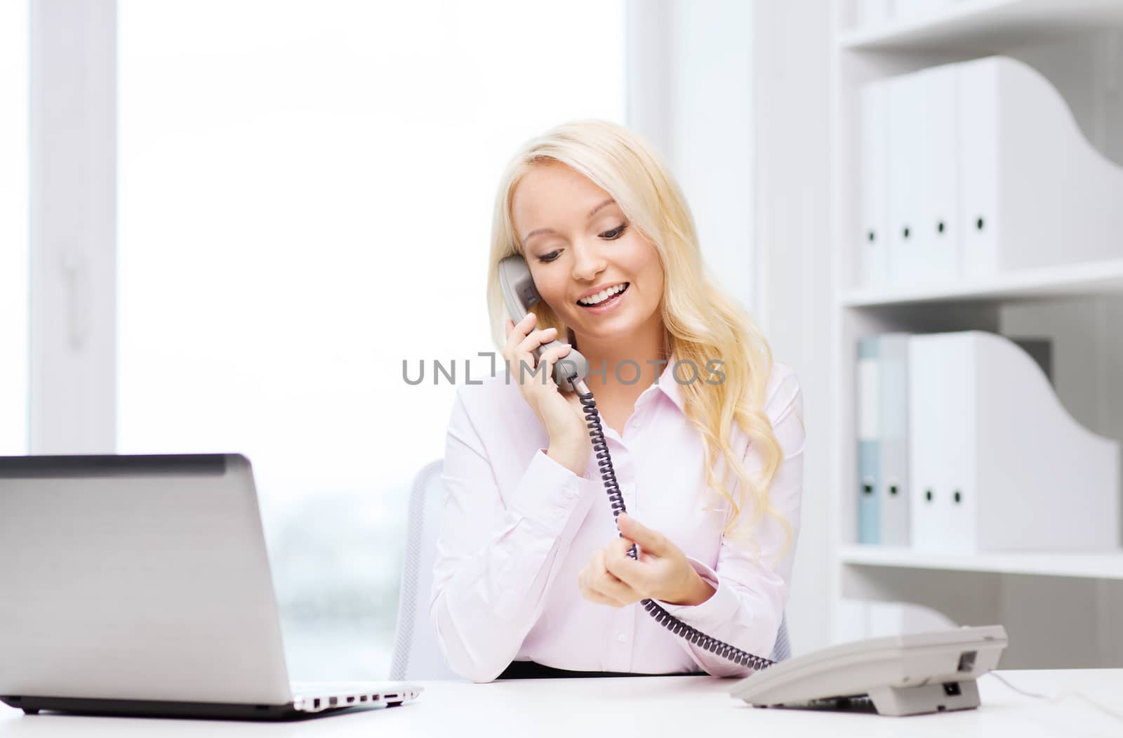smiling businesswoman or student calling on phone by dolgachov