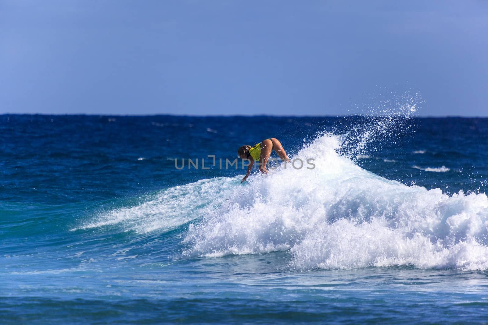 SNAPPER ROCKS, GOLD COAST, AUSTRALIA - 9 MARCH: Unidentified Surfer races the Quiksilver & Roxy Pro World Title Event. 9 March 2013, Snapper Rocks, Gold Coast, Australia