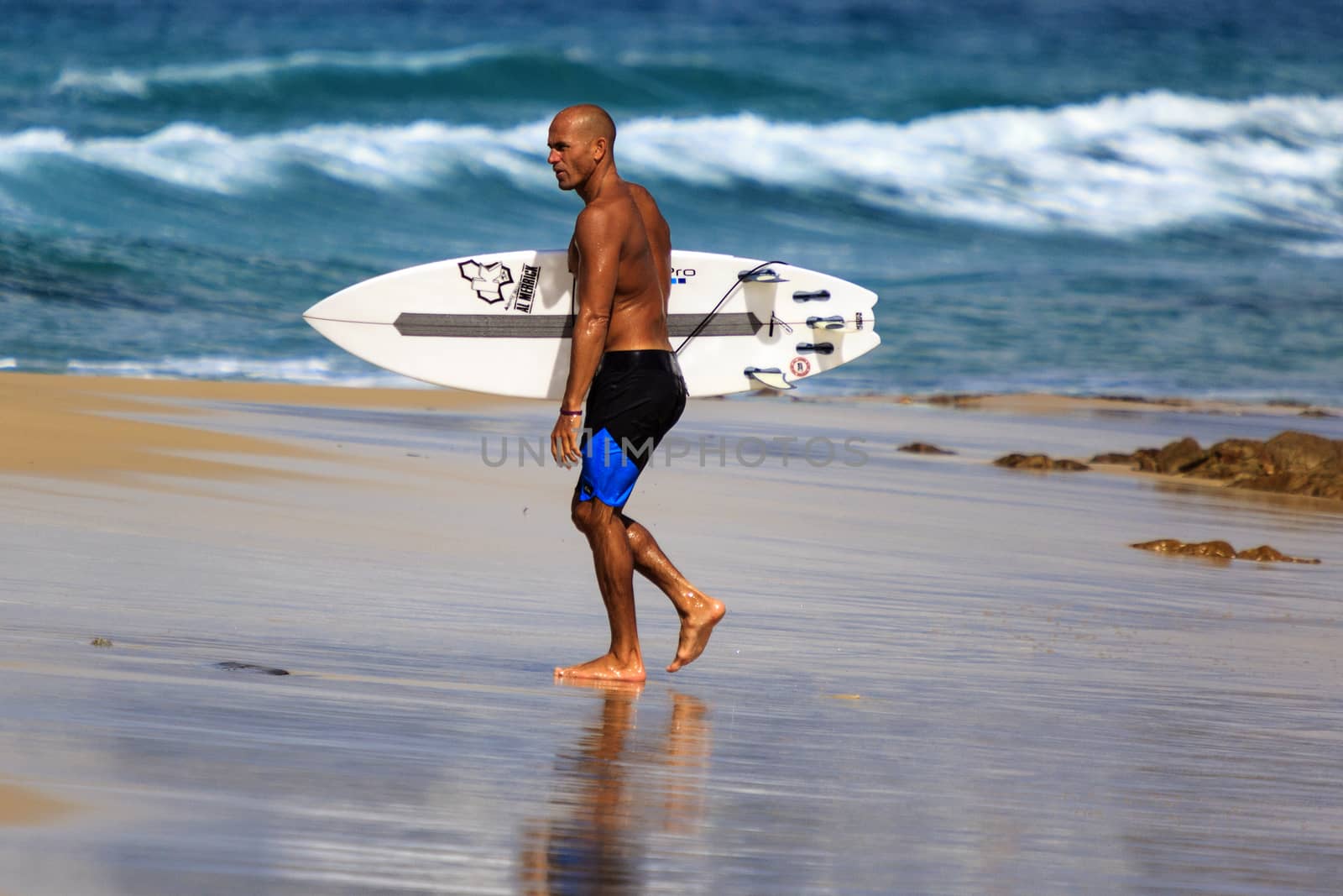 SNAPPER ROCKS, GOLD COAST, AUSTRALIA - 9 MARCH: Unidentified Surfer races the Quiksilver & Roxy Pro World Title Event. 9 March 2013, Snapper Rocks, Gold Coast, Australia