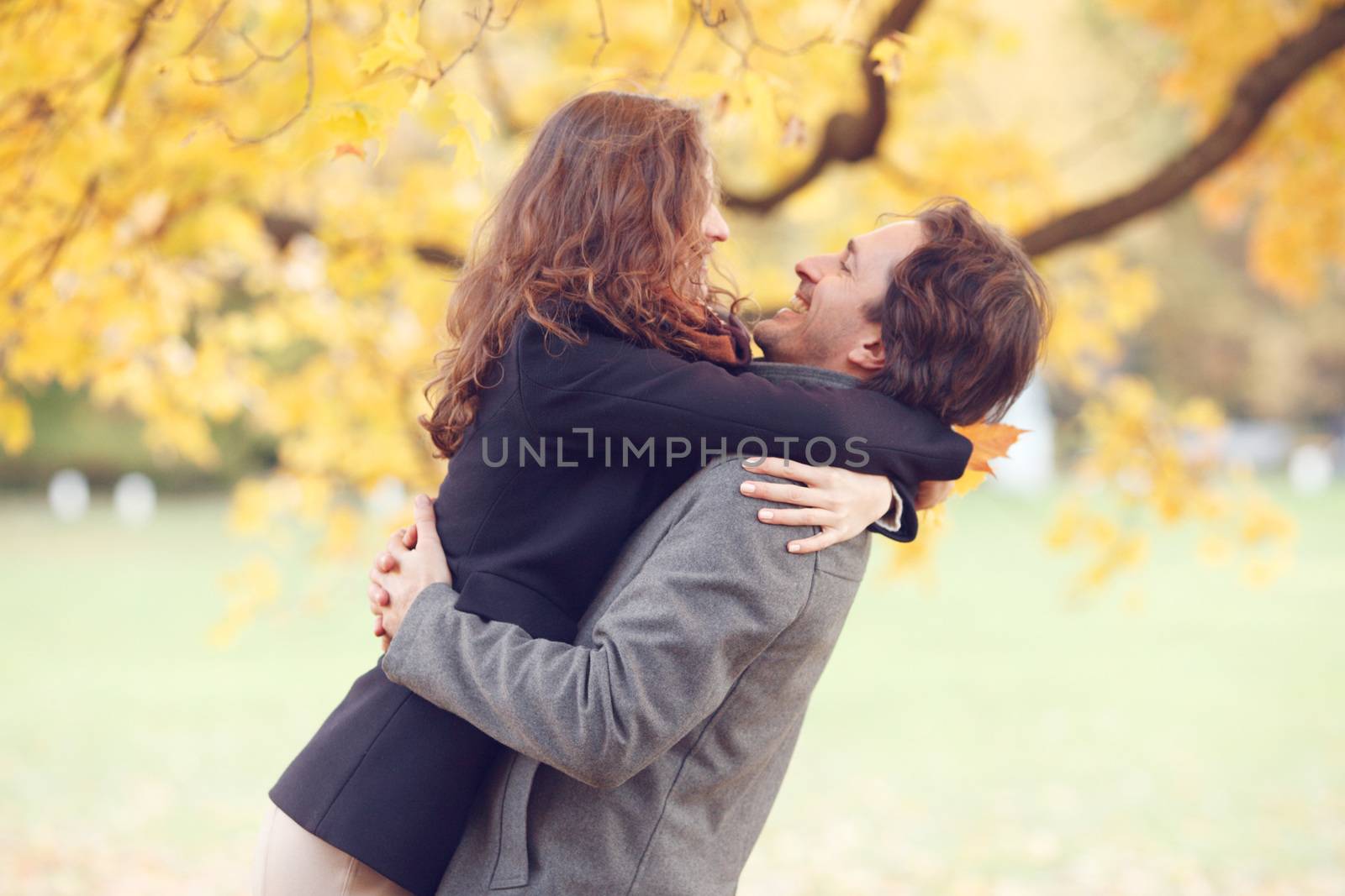 Couple hugging in autumn park by ALotOfPeople