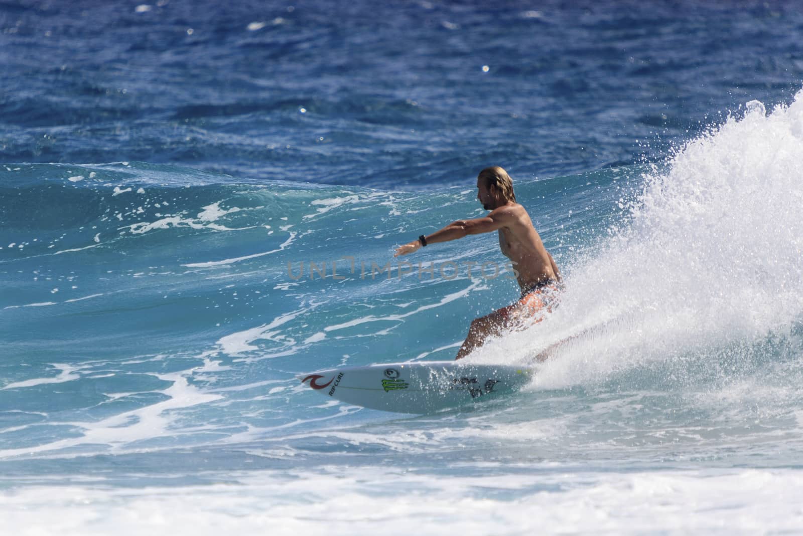 Surfer races the Quiksilver & Roxy Pro World Title Event by Imagecom