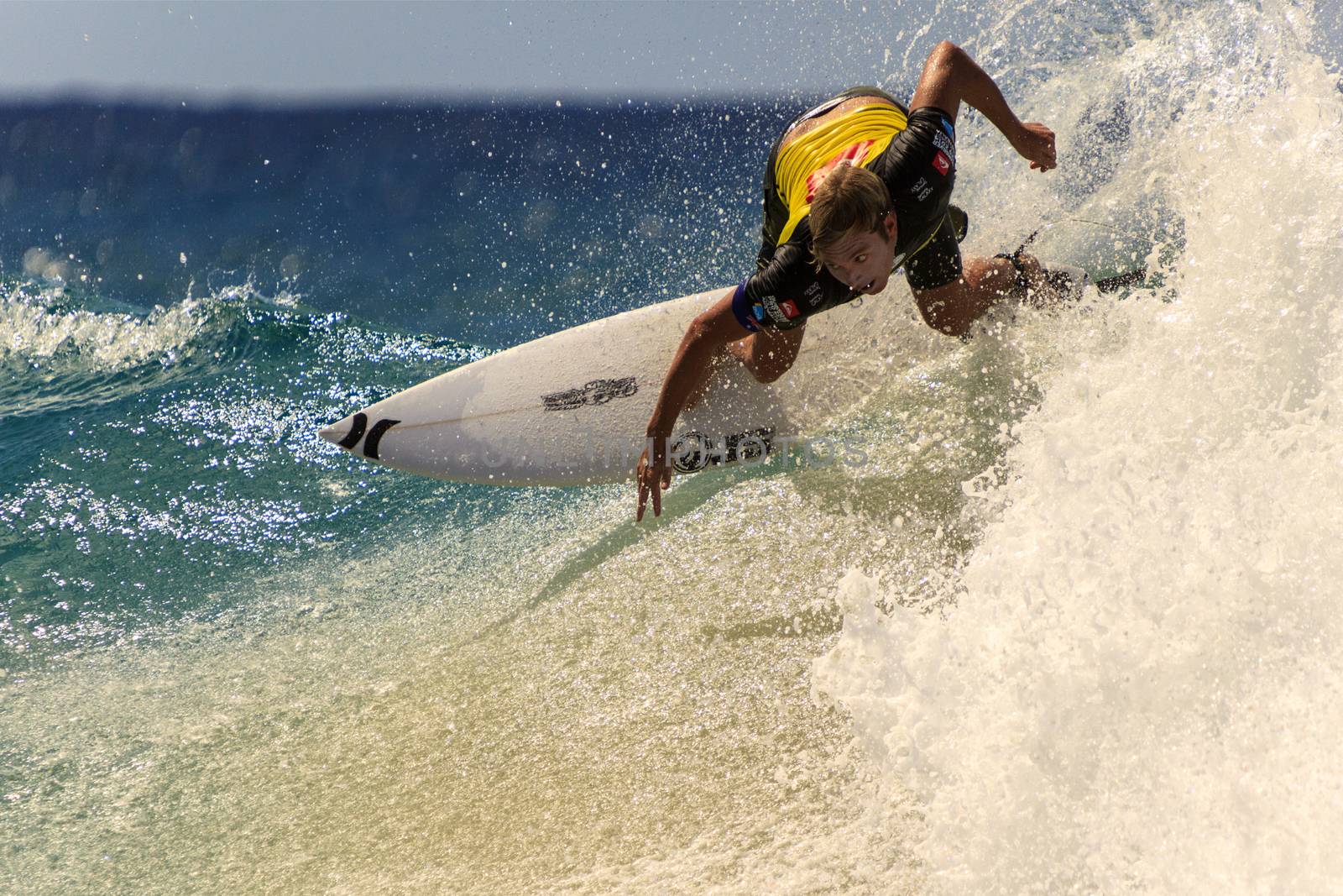 Surfer races the Quiksilver & Roxy Pro World Title Event by Imagecom