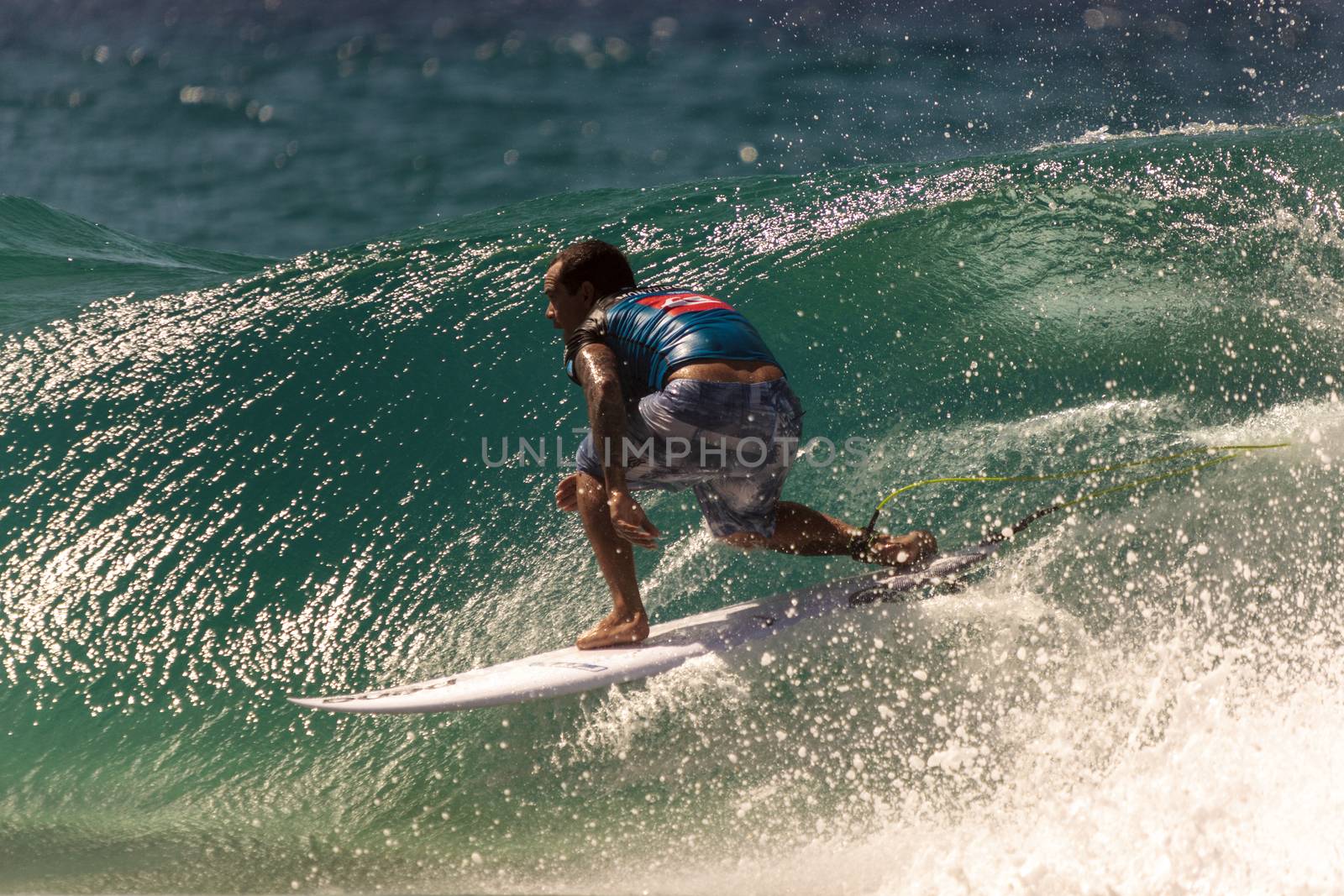 Surfer races the Quiksilver & Roxy Pro World Title Event by Imagecom