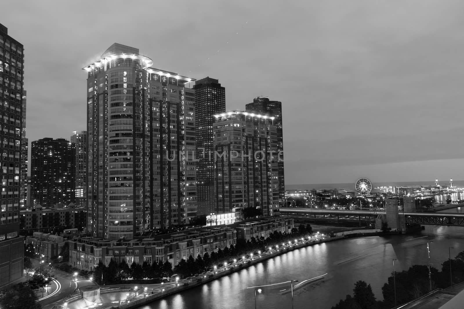 Chicago buildings, towering overhead, overground railway, urban road and lights streams with light flares from street lights, Illinois, USA