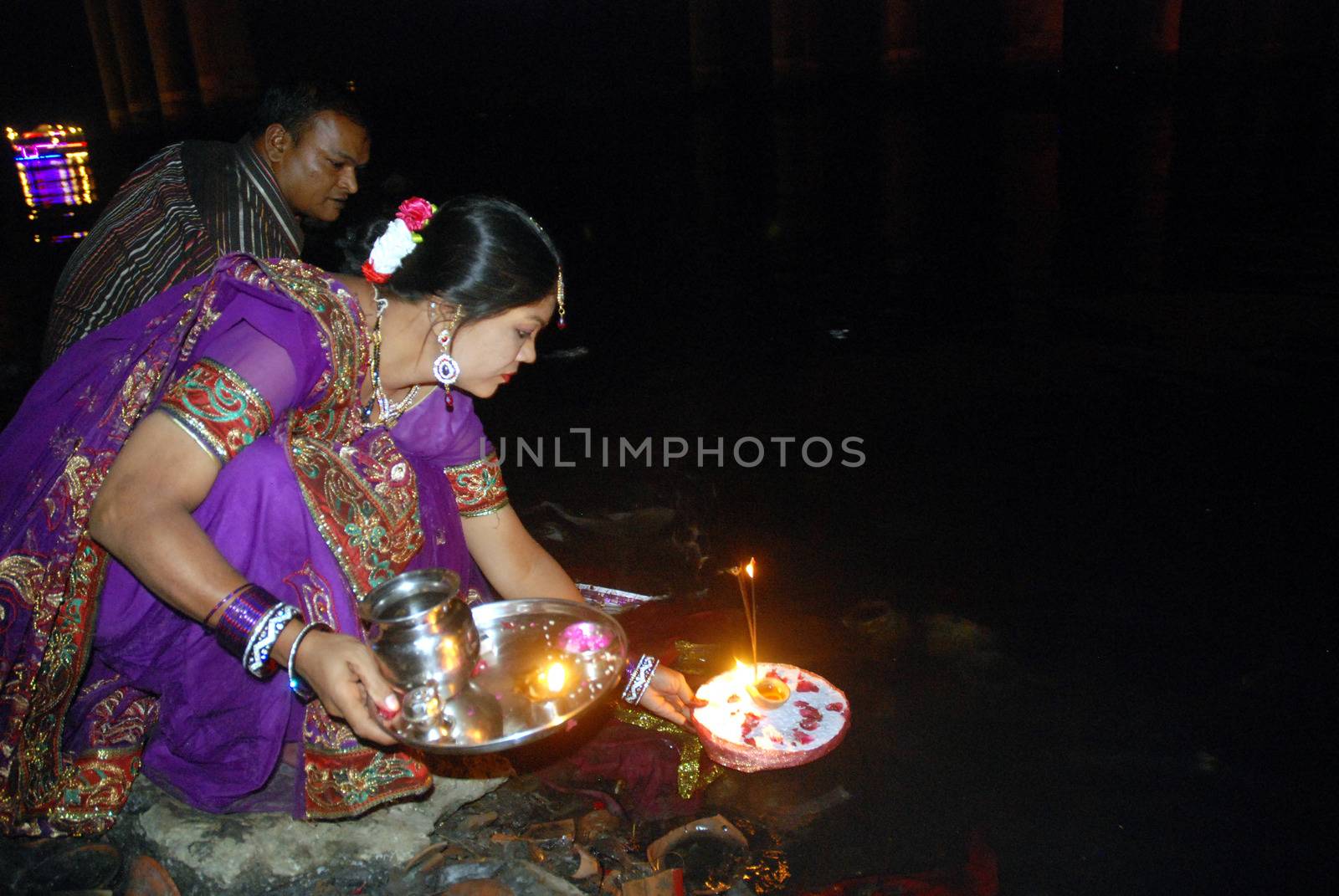 PAKISTAN, Karachi :  A married Hindu woman and her husband light candles at the Netty Jetty temple during the Karva Chauth festival in Karachi on October 30, 2015. Married women observe Karvachauth by fasting and offering prayers seeking welfare, prosperity, and longevity of their husbands.