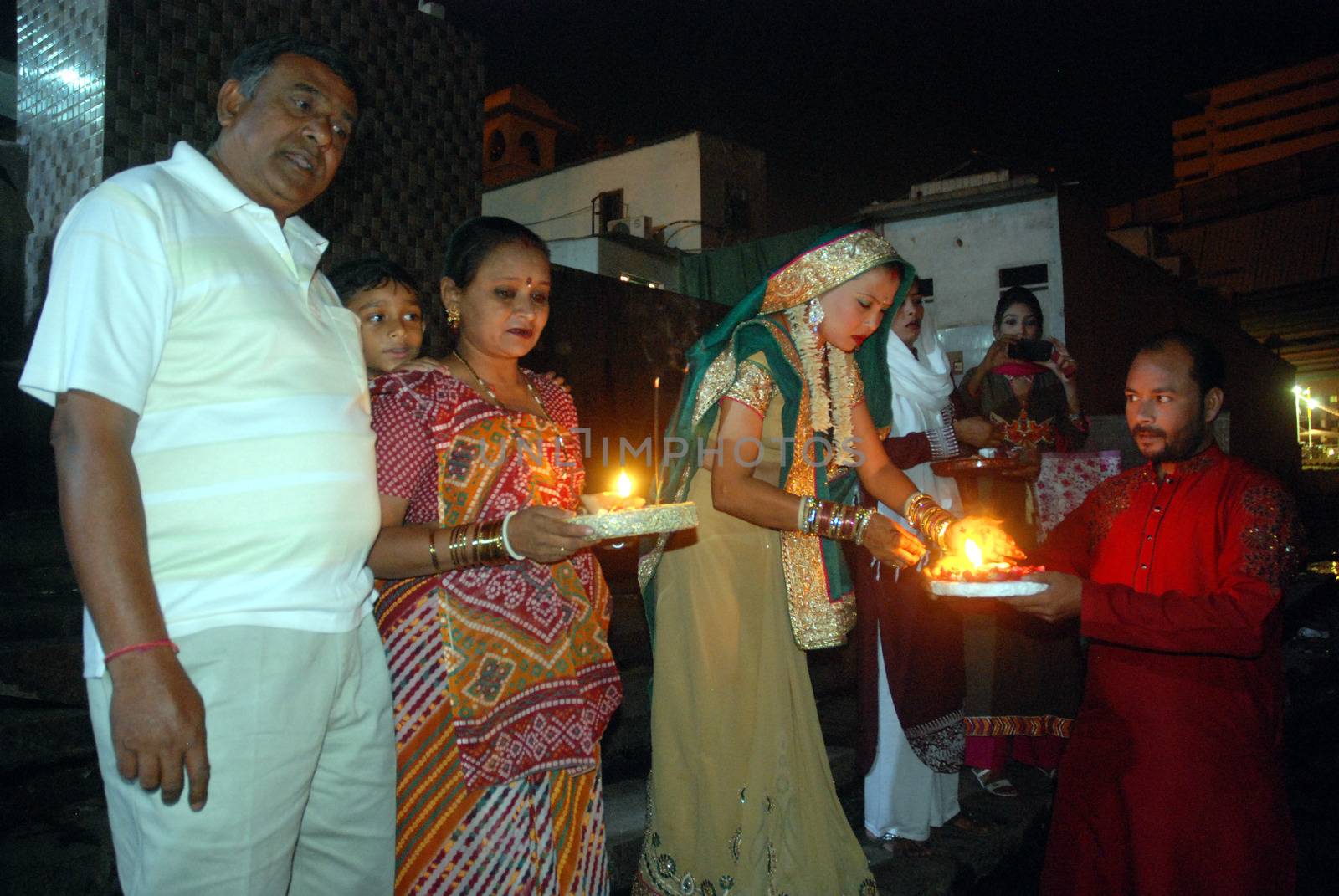PAKISTAN, Karachi :  Married Hindu women and their husband light candles at the Netty Jetty temple during the Karva Chauth festival in Karachi on October 30, 2015. Married women observe Karvachauth by fasting and offering prayers seeking welfare, prosperity, and longevity of their husbands.