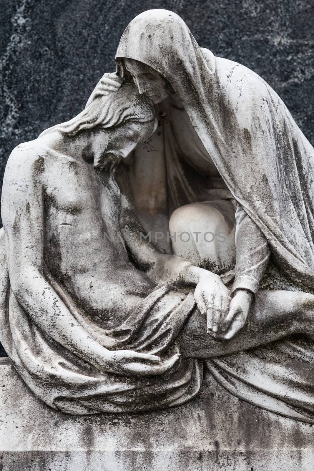 More than 100 years old statue. Cemetery located in North Italy.