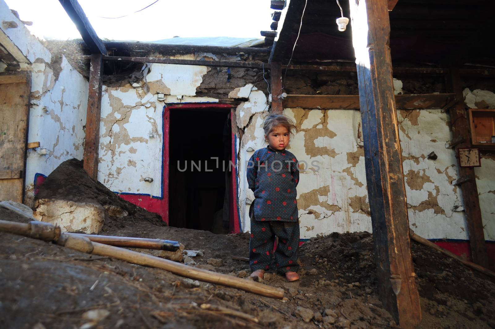 PAKISTAN, Tor Ghar: A Pakistani earthquake survivor looks on among the rubble of his damaged house in Tor Ghar near Sibi city, on October 28, 2015.  The powerful 7.5-magnitude earthquake that struck on October 26 ripped across Afghanistan and Pakistan, killing nearly 390 people and levelling thousands of homes, forcing many to camp out in the open. The army has led the rescue effort in Pakistan while the government has promised aid and compensation, but with many of the affected communities isolated by rugged terrain, help may not arrive before the snow does. 