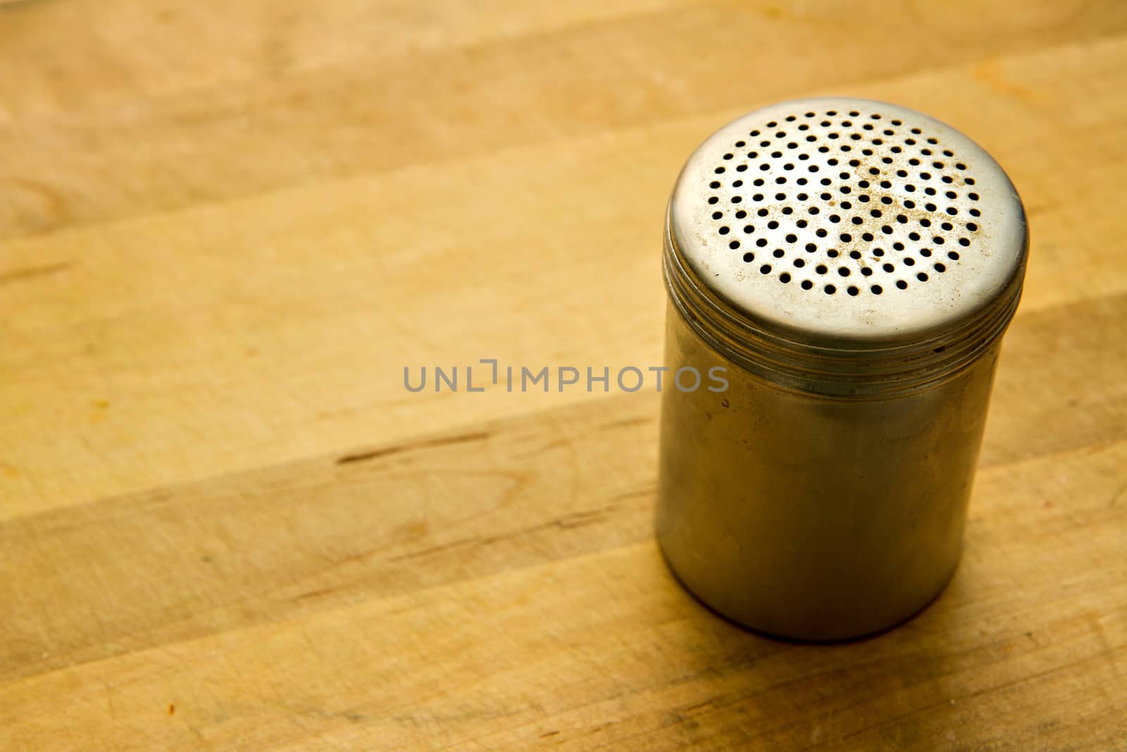 Pepper shaker on a wooden counter