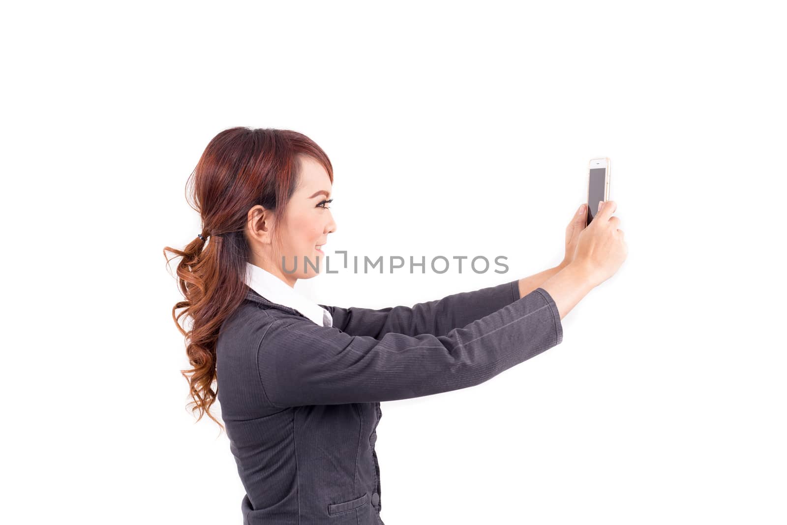 Young business woman holding cellphone on white background by powerbeephoto