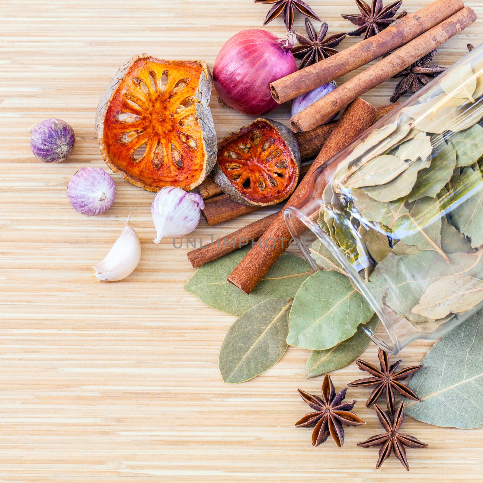 Assortment of Thai food Cooking ingredients in glass bottles on wooden background.