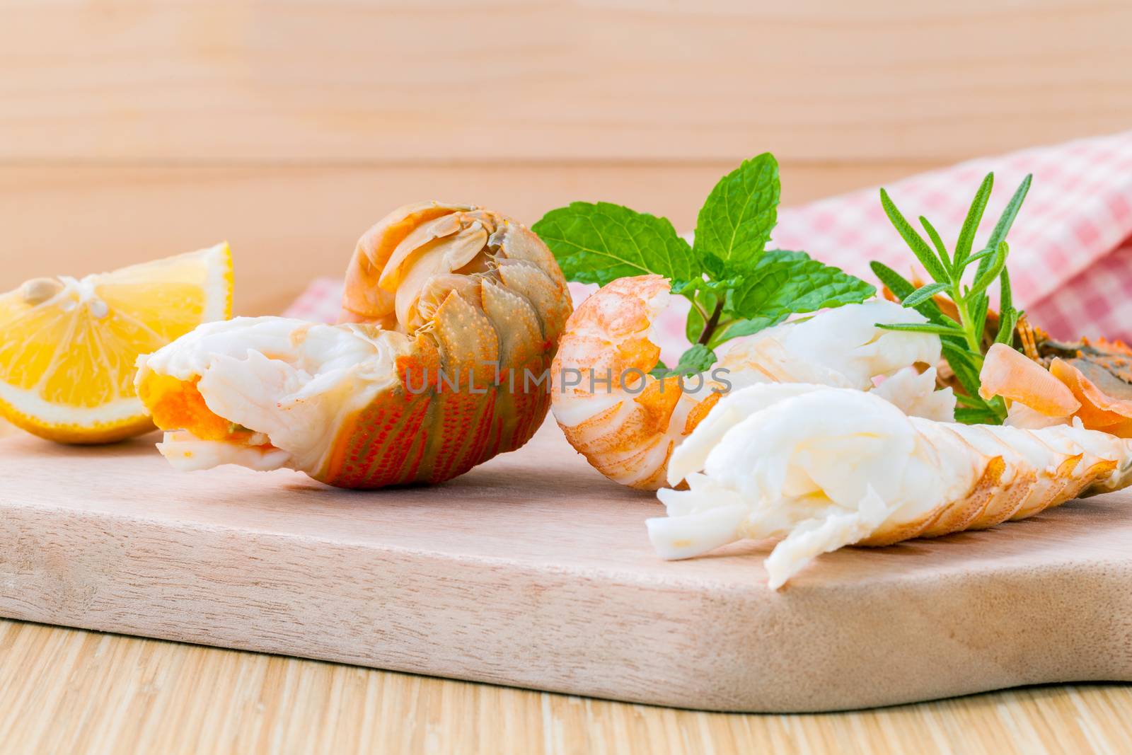 Boiled Flathead lobster, Lobster Moreton Bay bug, Oriental flathead lobster with herbs and spices  sauce wooden background.