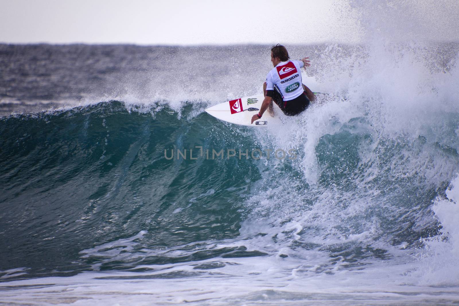 Surfer races the Quiksilver & Roxy Pro World Title Event.  2012 by Imagecom