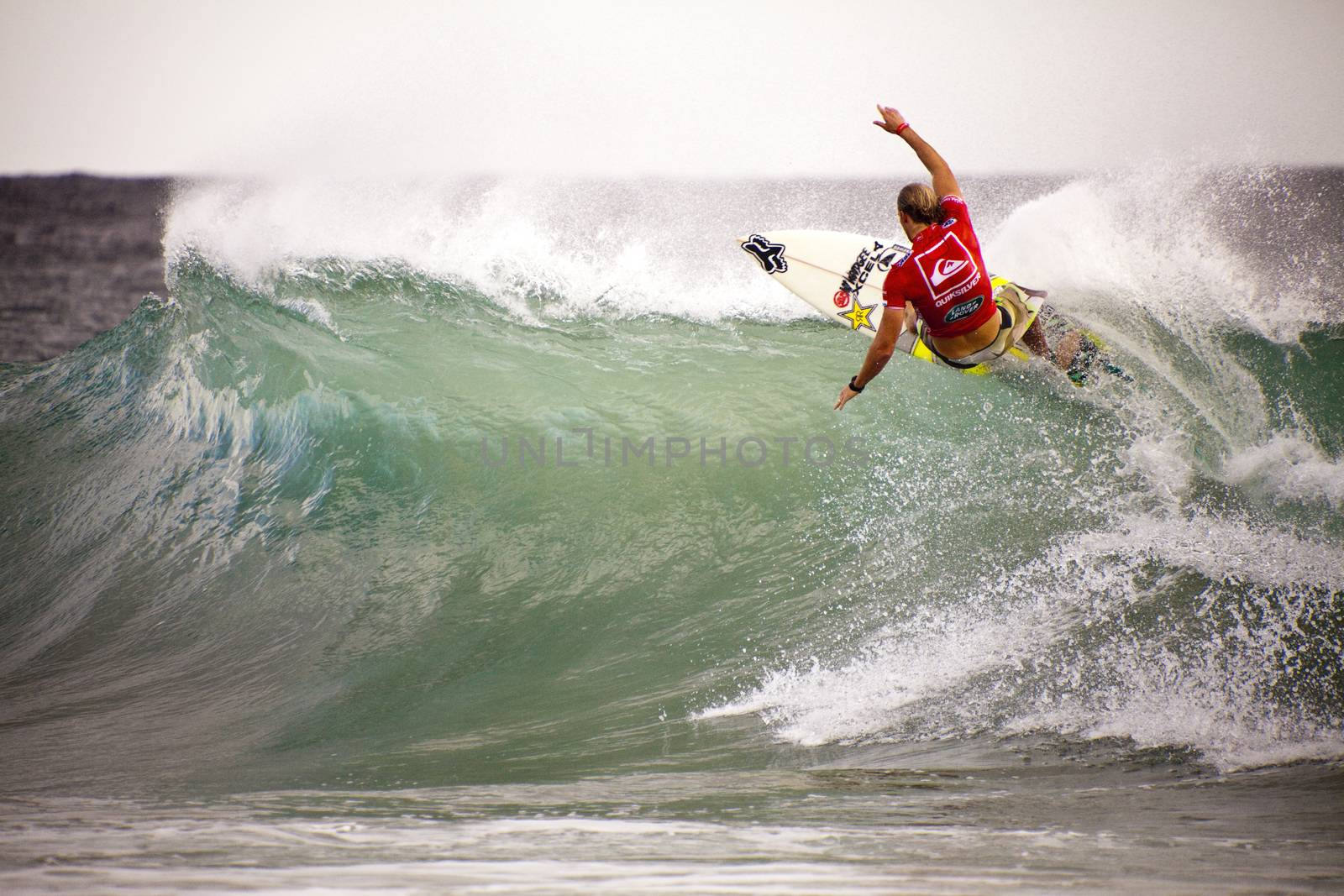 Surfer races the Quiksilver & Roxy Pro World Title Event.  2012 by Imagecom