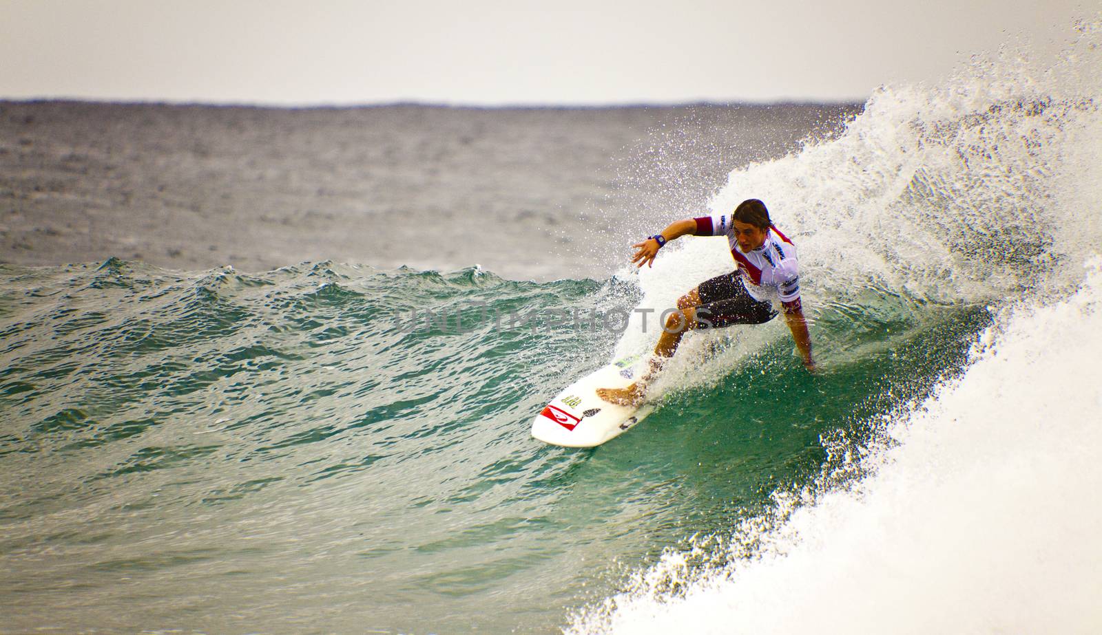 Surfer races the Quiksilver & Roxy Pro World Title Event.  2012 by Imagecom