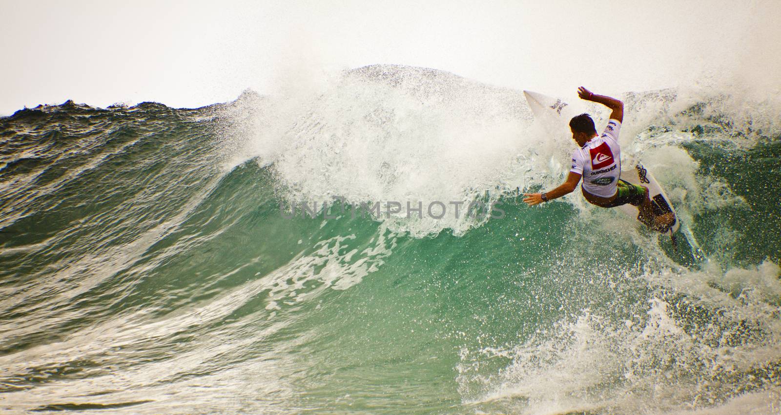 Surfer races the Quiksilver & Roxy Pro World Title Event.  2012 by Imagecom