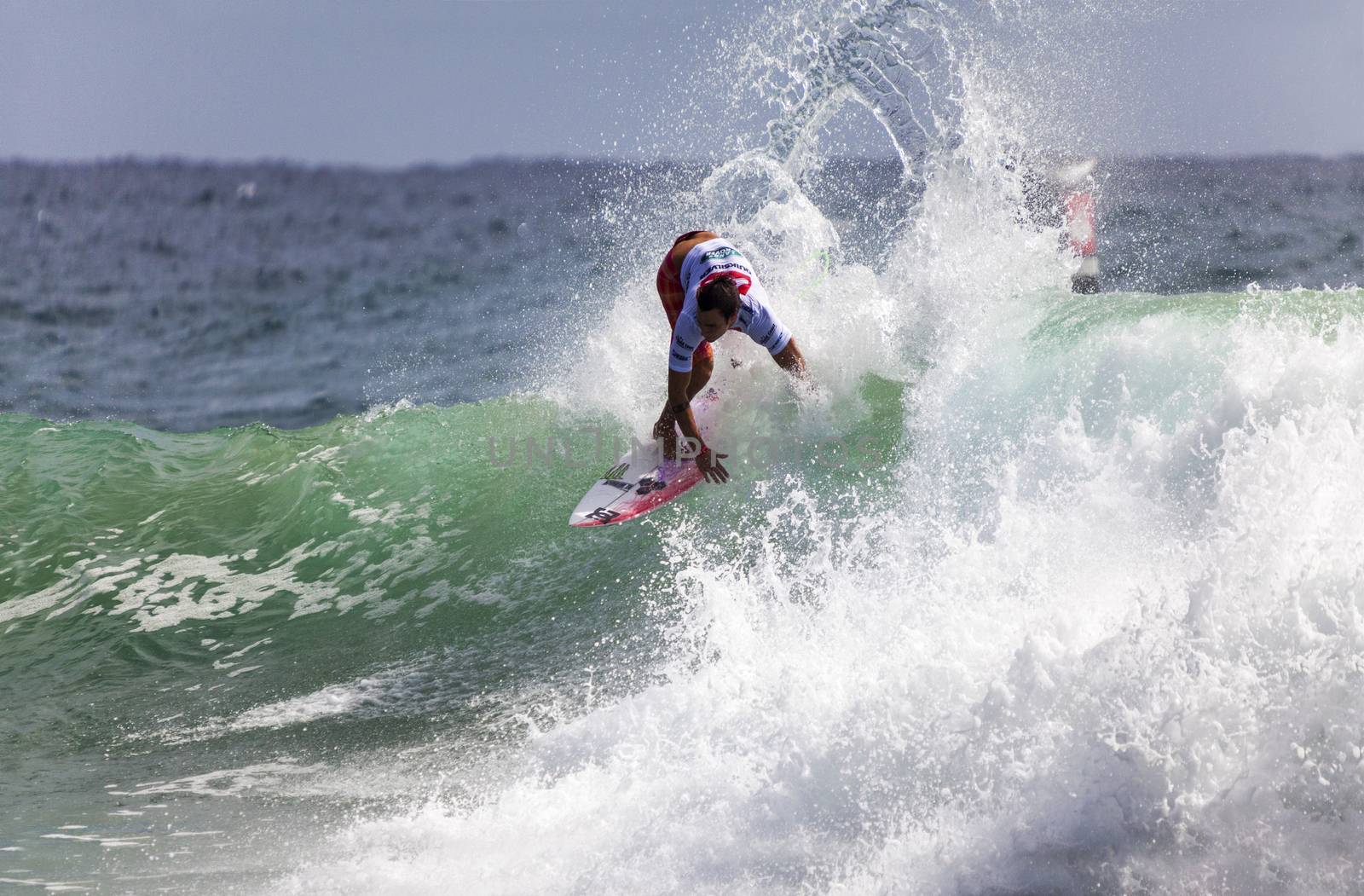 Surfer races the Quiksilver & Roxy Pro World Title Event.  2012 by Imagecom