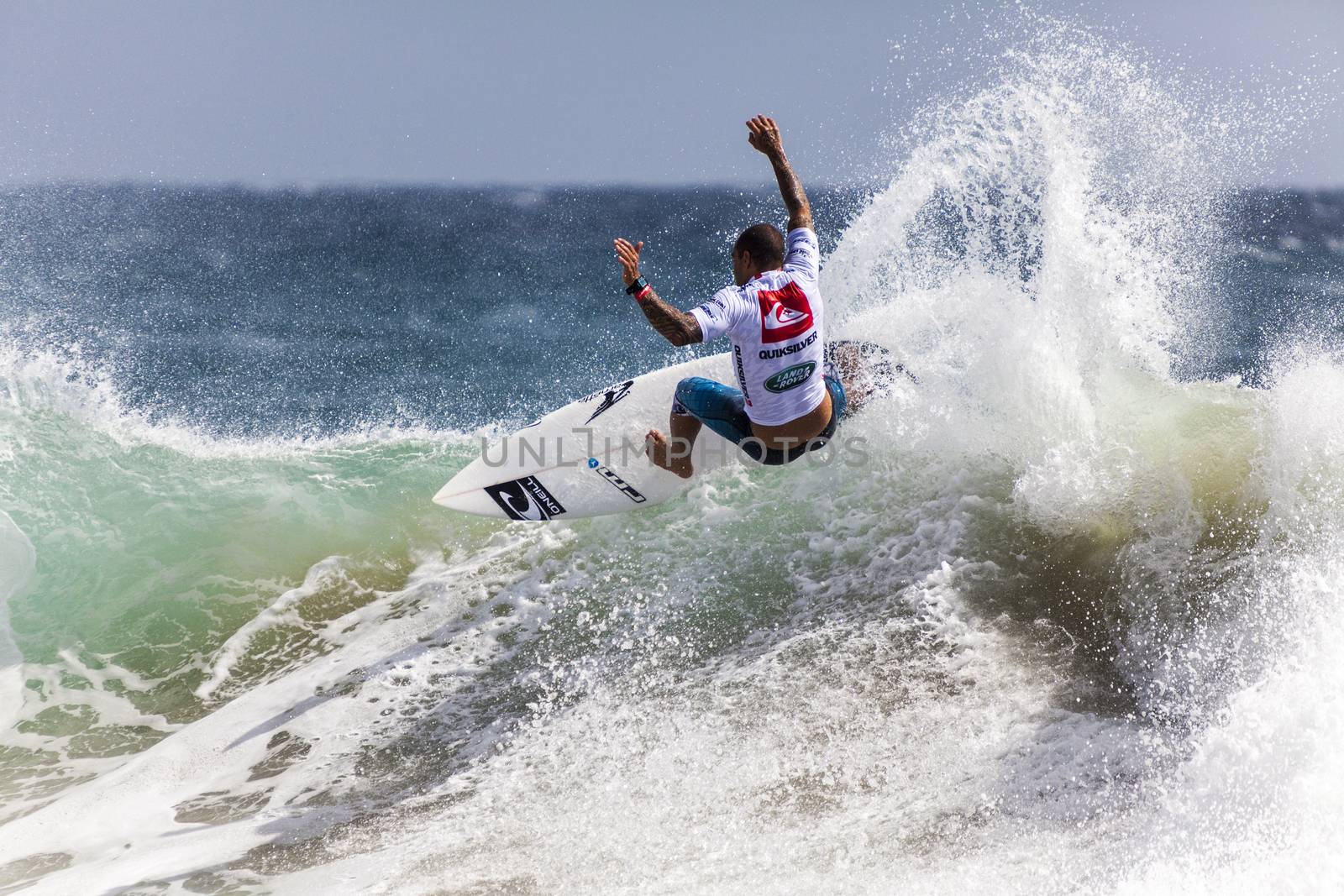 Surfer races the Quiksilver & Roxy Pro World Title Event.  2012 by Imagecom