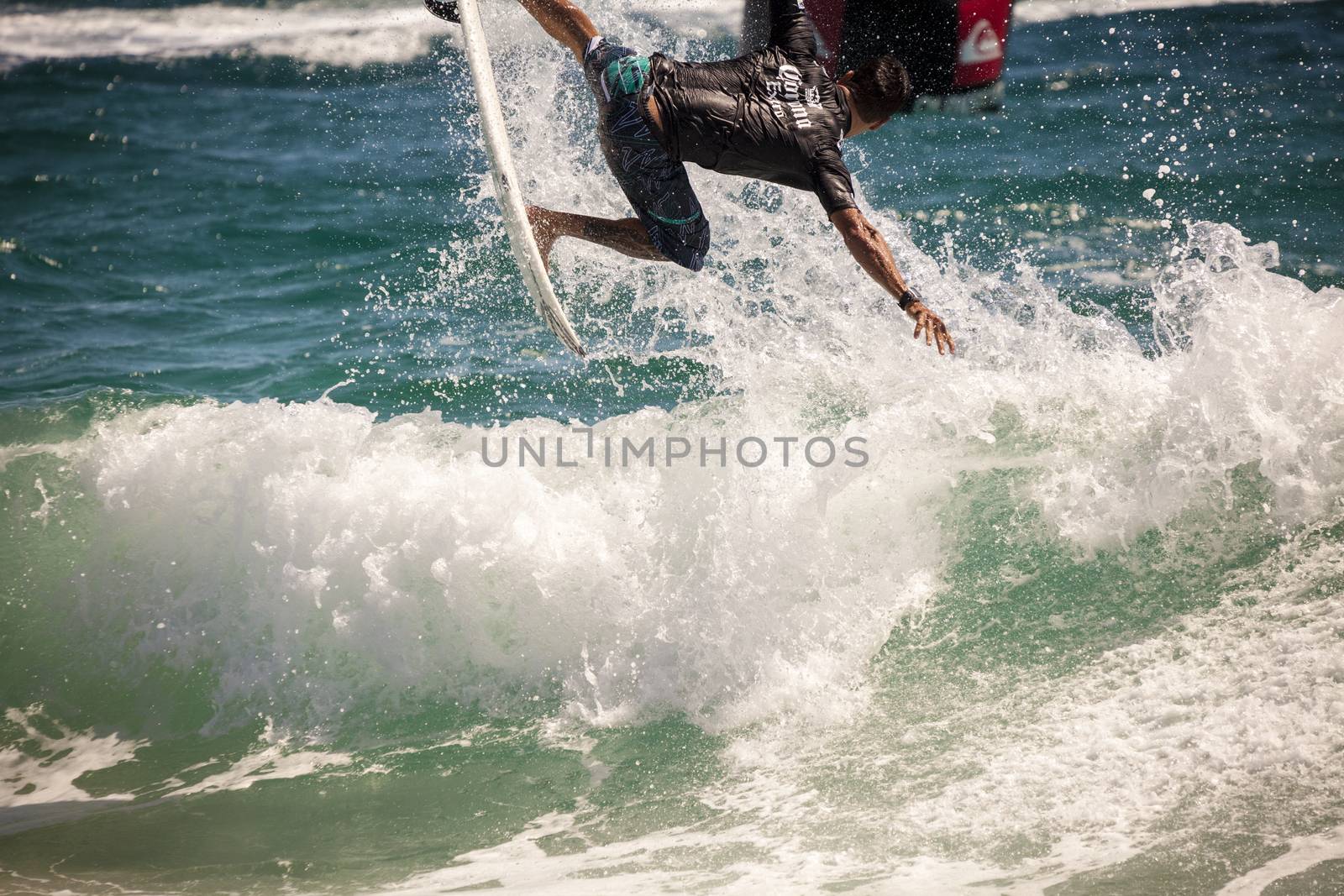 Surfer races the Quiksilver & Roxy Pro World Title Event.  2012 by Imagecom