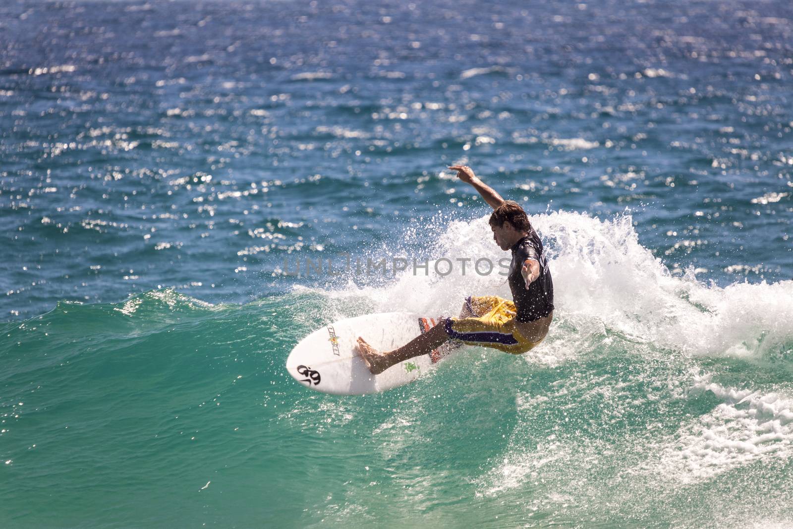 Surfer races the Quiksilver & Roxy Pro World Title Event.  2012 by Imagecom